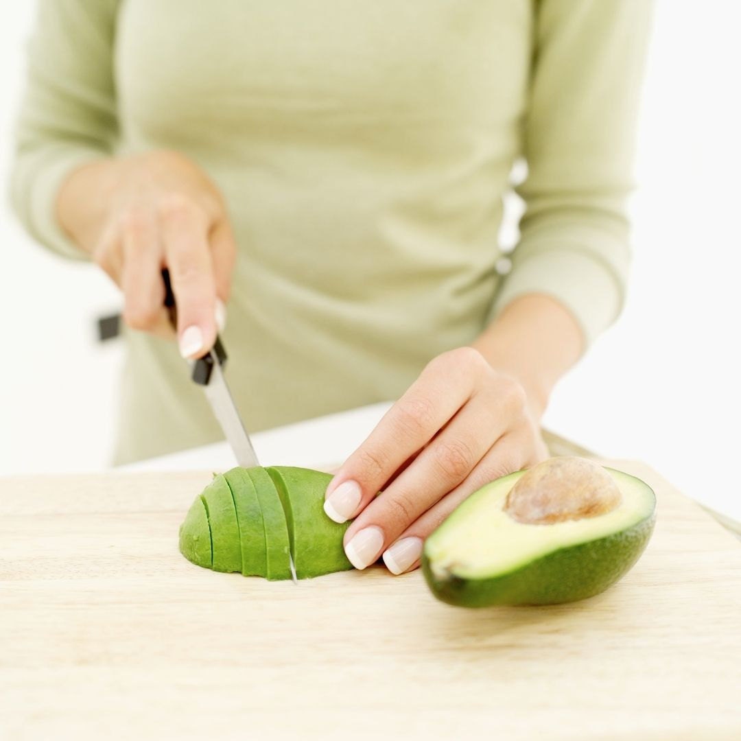 woman slicing avocado
