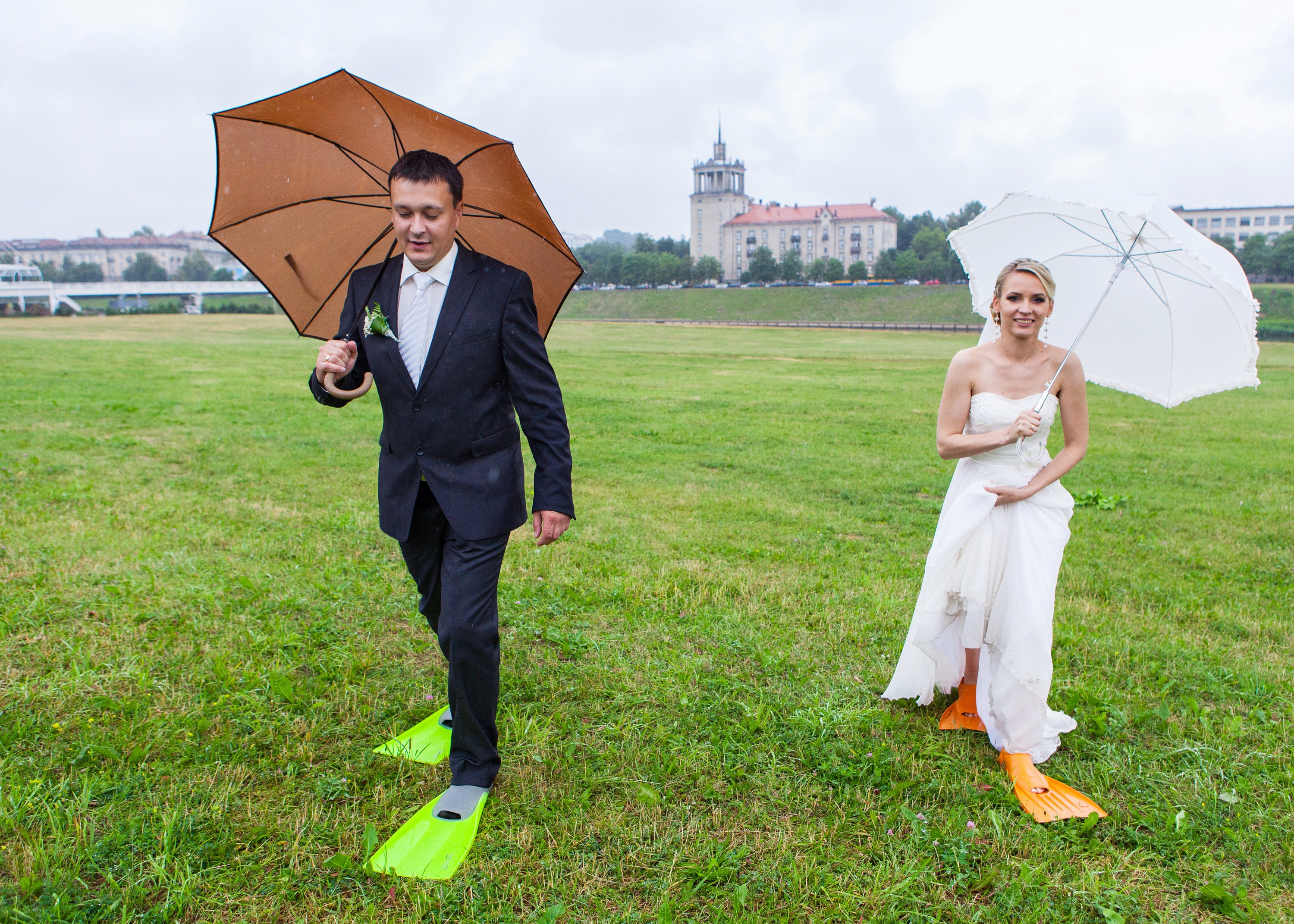 wedding couple getting rained on