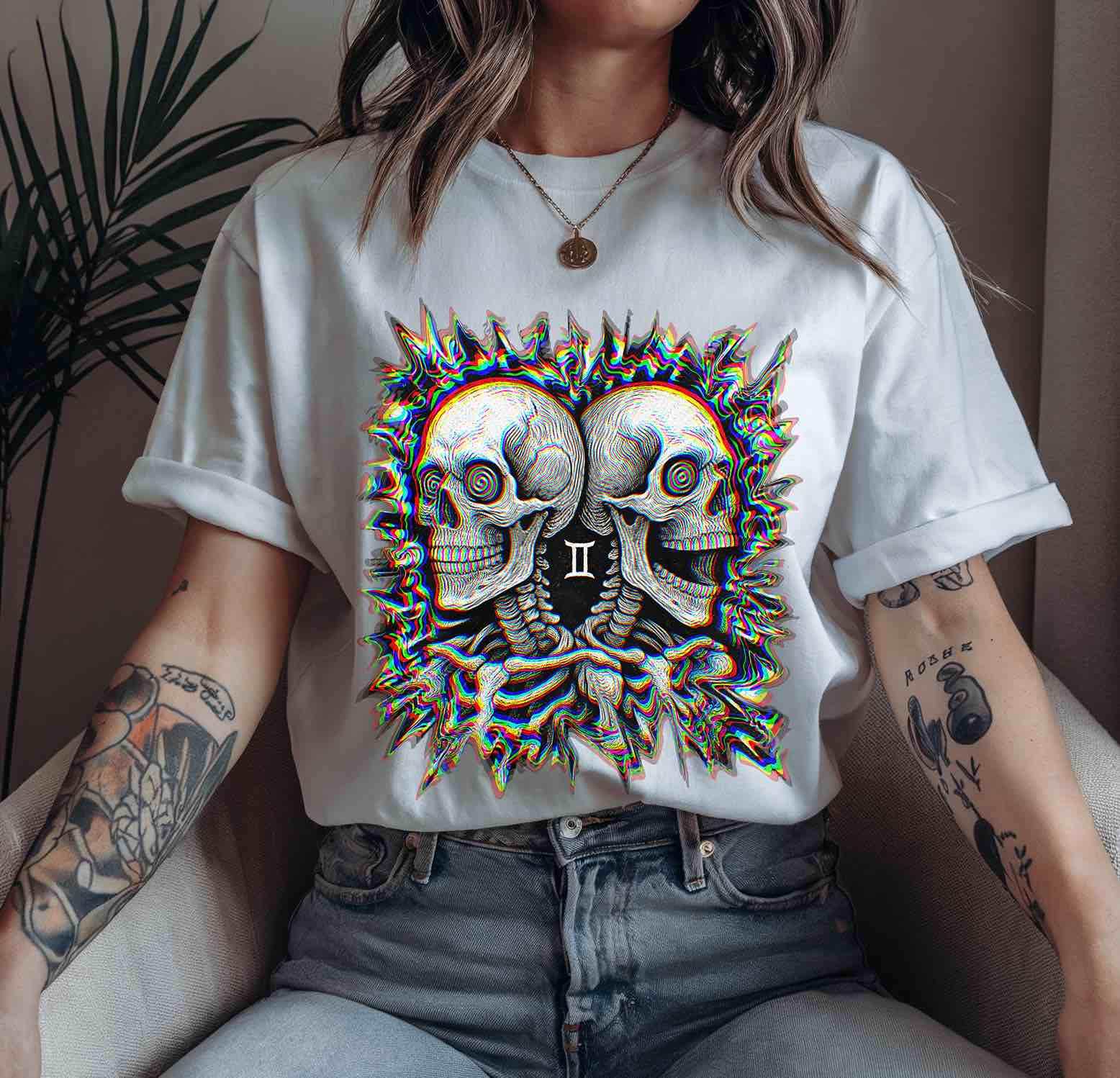 Unisex white t-shirt with twin skull Gemini neon-glitch artwork; gothic rave streetwear for altwear festival fans.