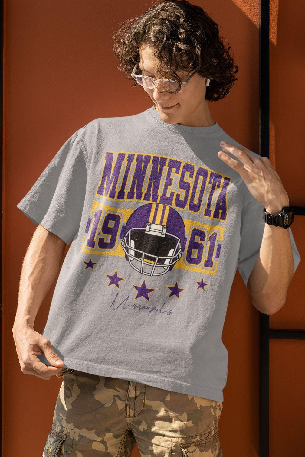 Retro Minnesota football graphic—purple and gold varsity ‘MINNESOTA,’ 1961 numbers, classic helmet, five stars, ‘Minneapolis’ script.