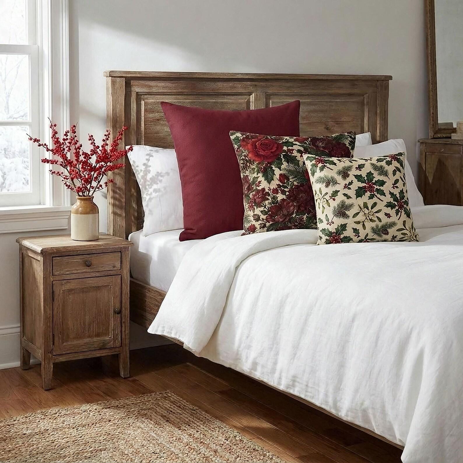 French cottage Christmas bedroom with cranberry red, winter rose and holly berry pillows on a white bed