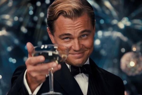 Leonardo DiCaprio raising glass of champagne