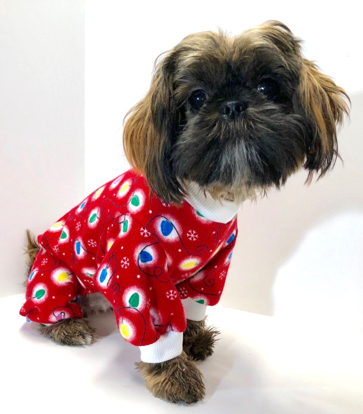 our rescue shih tzu wearing christmas onesie. she is such a sweetheart.
