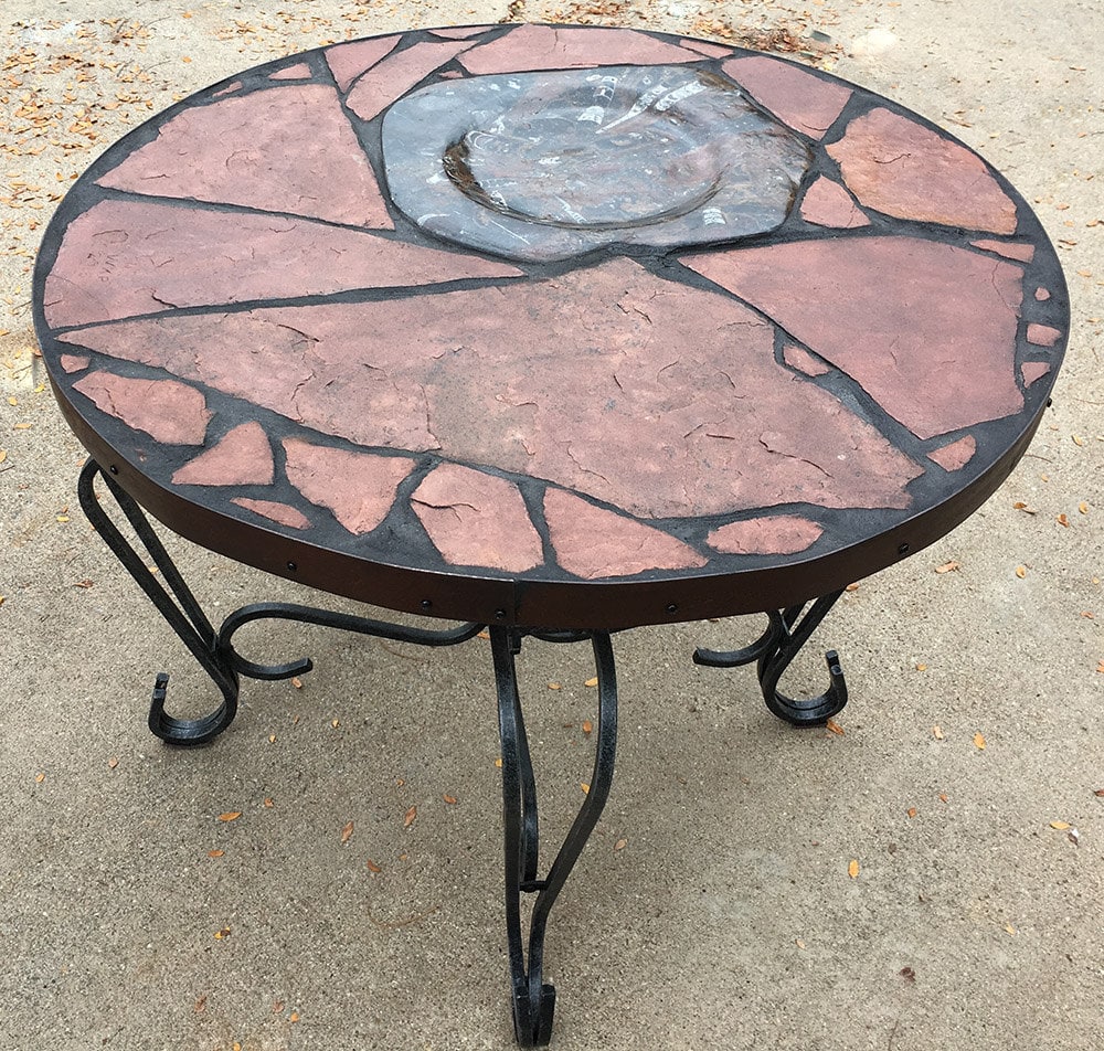 Moroccan Moon 2: A natural stone topped table featuring Moroccan fossils