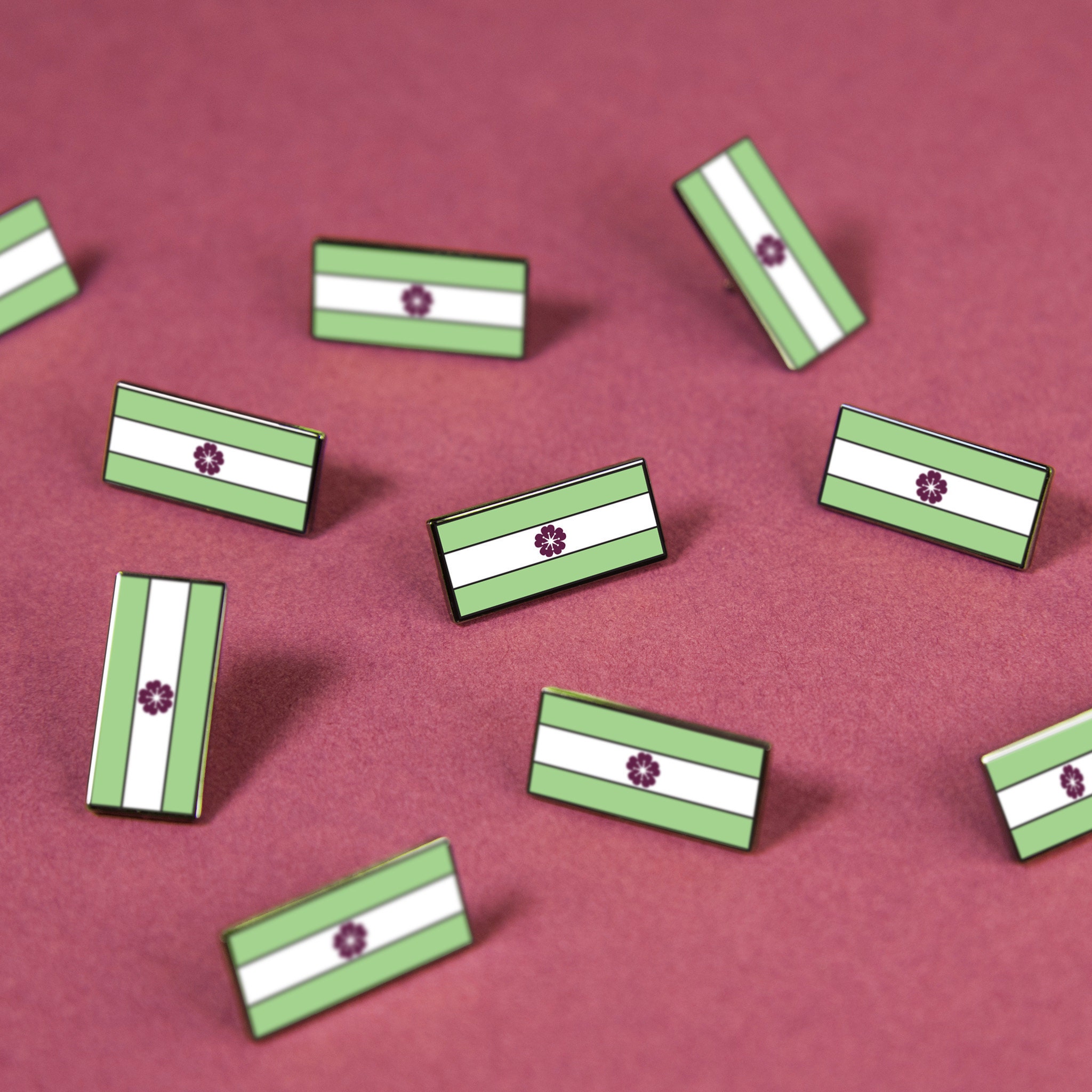 Enamel pin featuring the Diamoric Pride Flag – pale green, white, and purple myrtle stripes, celebrating non-binary love