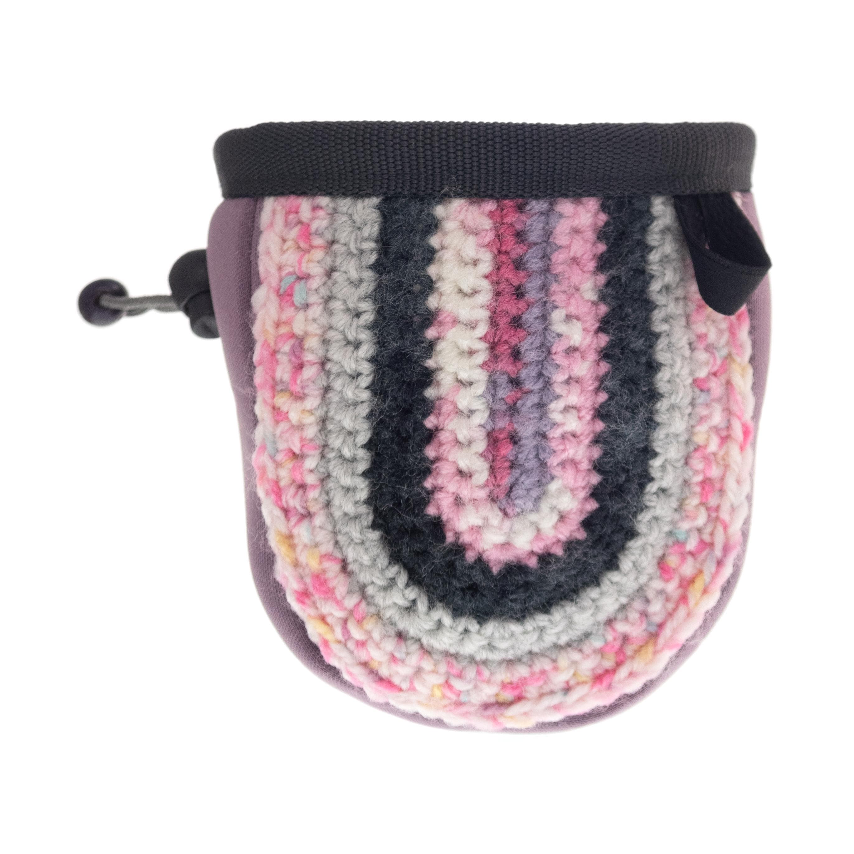 Compact childrens chalk bag in pink knit fabric, perfect for beginner climbers and active outdoor adventures.