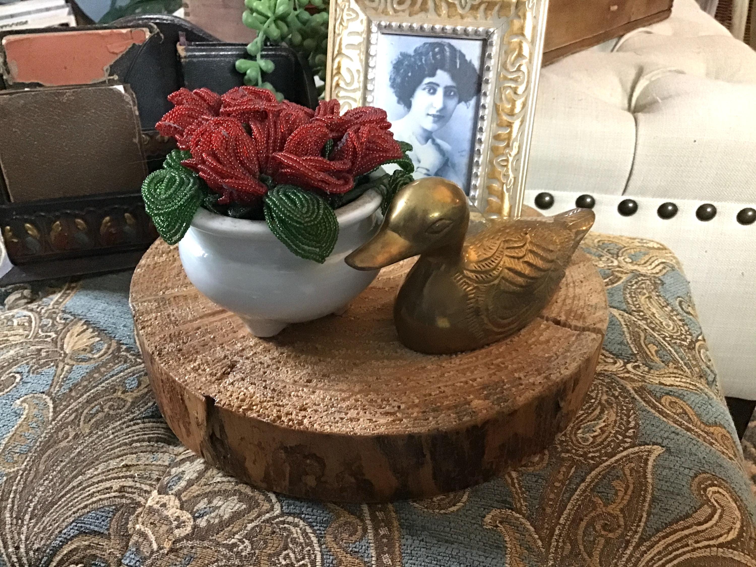 Create a small vignette on a slice of wood to showcase your favorite pieces