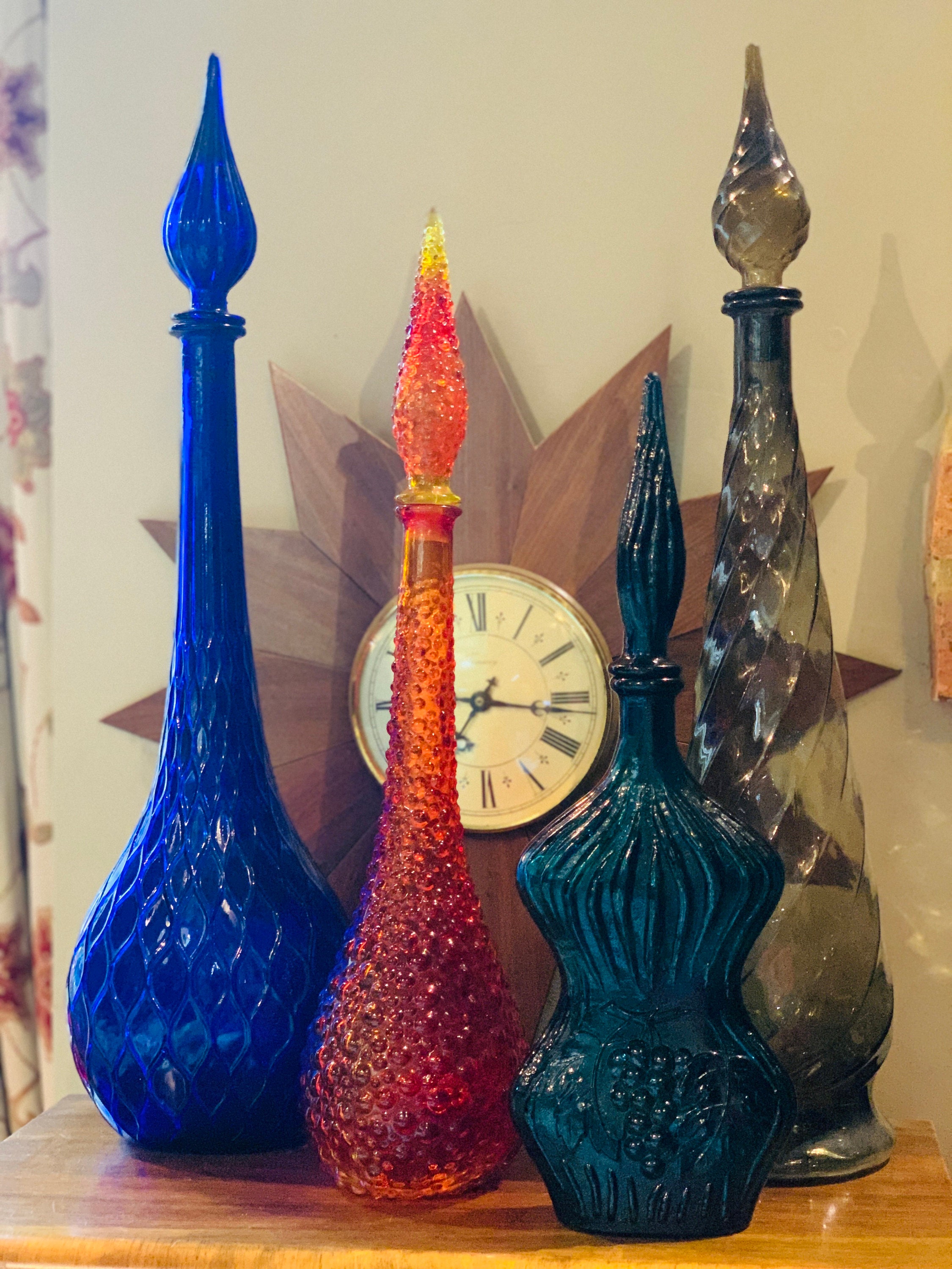 Four mid-century vintage Italian glass genie bottle decanters in cobalt, amberina, teal and smoke