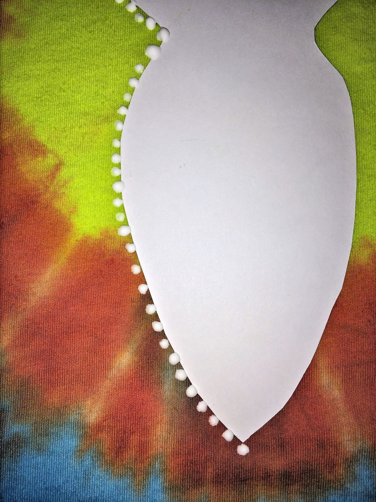 White puffy paint dots applied around the outside edge of the goddess pattern