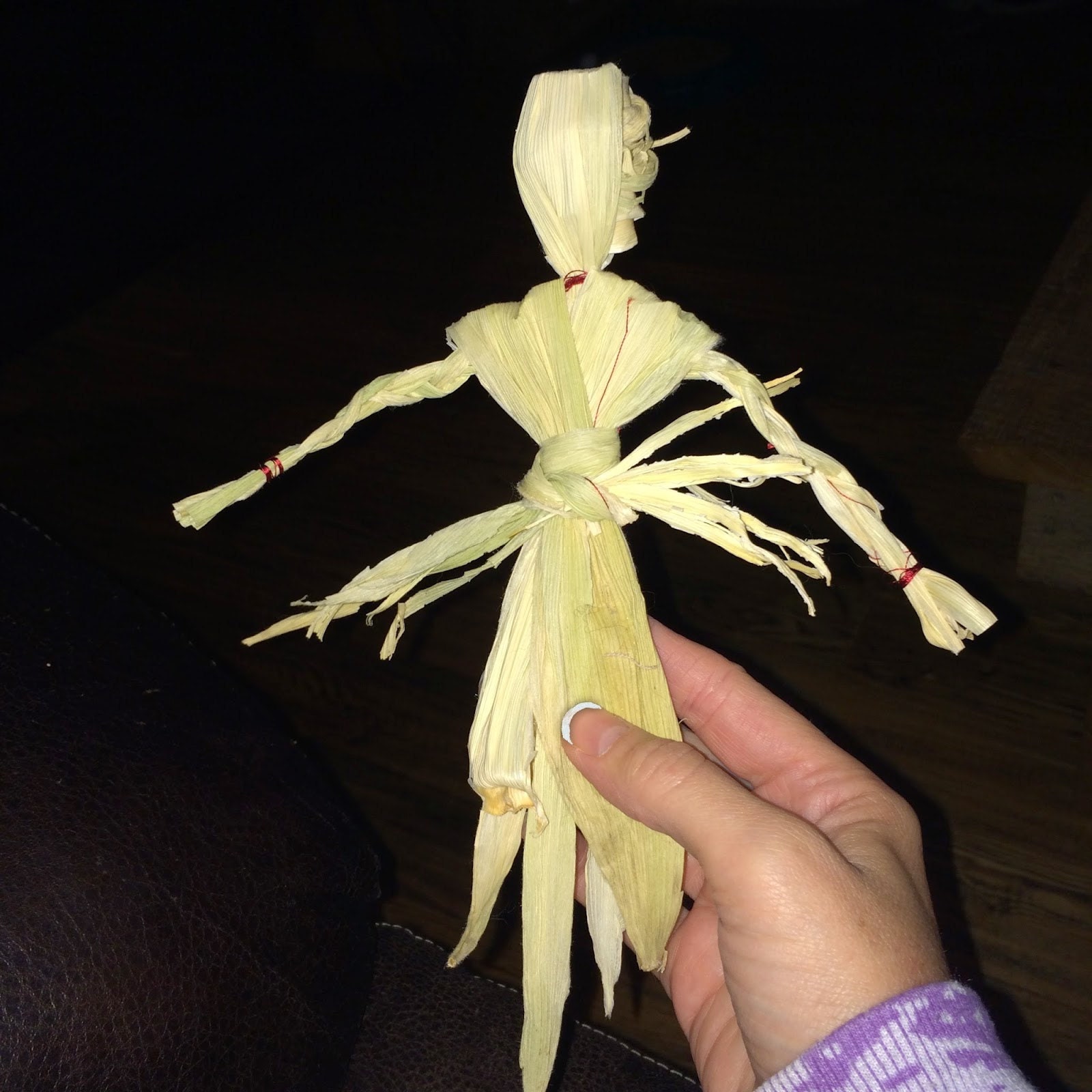 Husk tied at the waist of the girl corn dolly