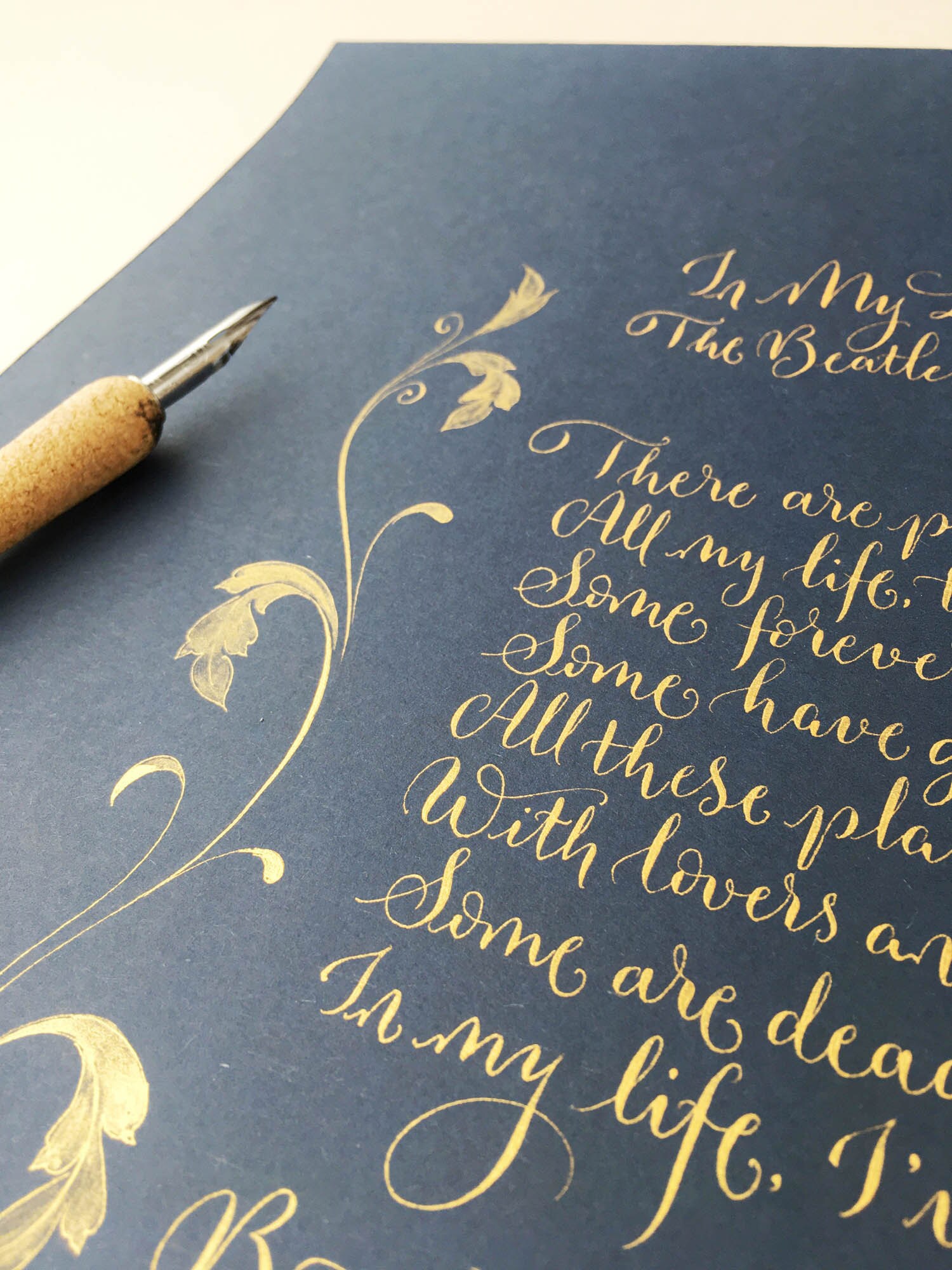 Straight modern calligraphy style with minimal flourishing and a classic gold border illustration