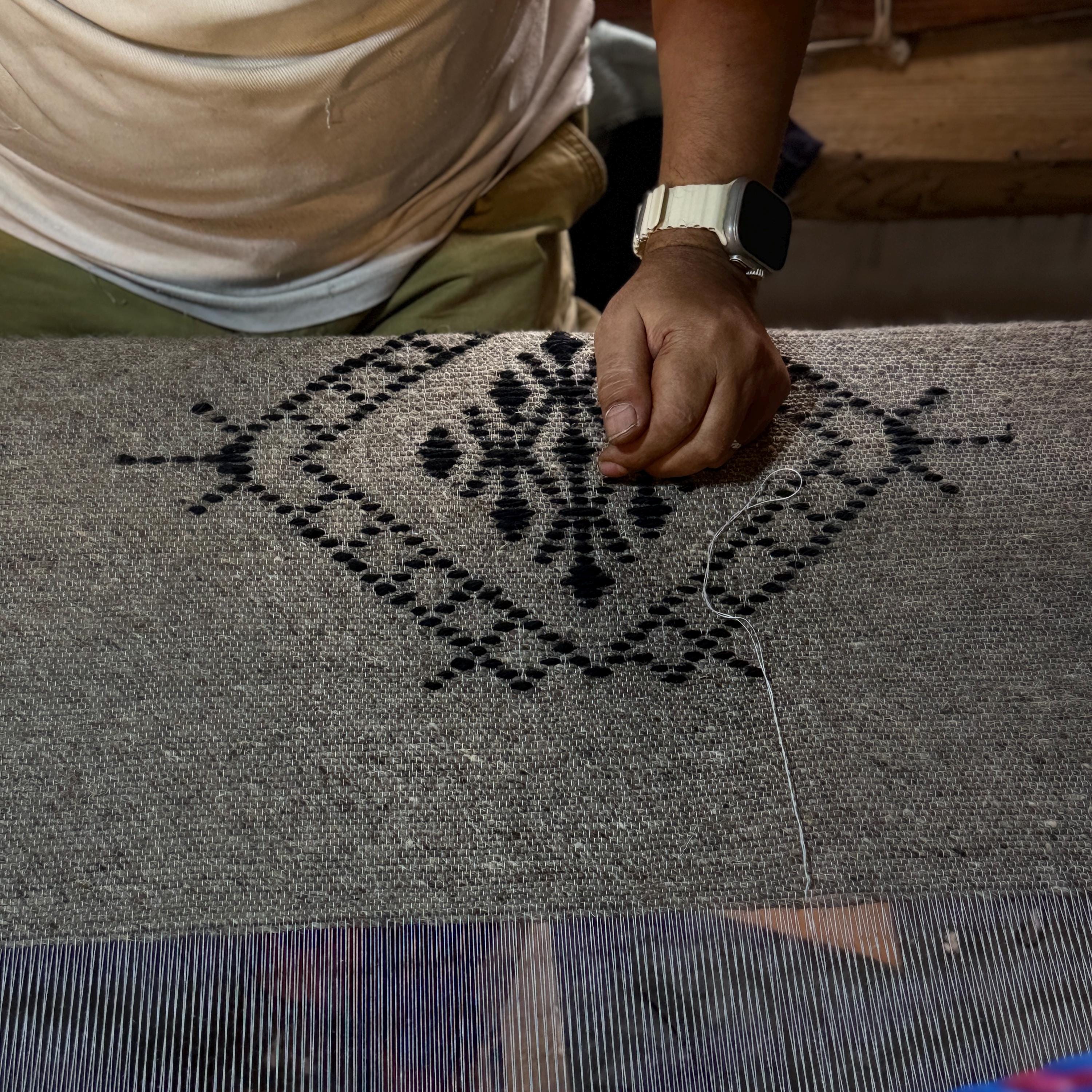 Figure 5. The motif forming dot by dot on the loom. This pattern is not drawn and copied — it is remembered and repeated.