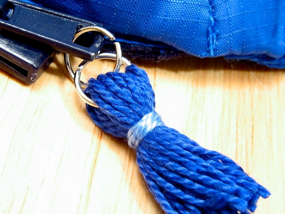 Blue zipper pull attached to zipper pull tab