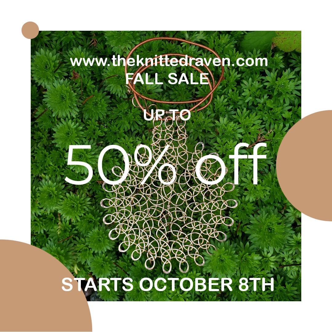 Bronze wire pendant, on natural leather cord, against a green plant background.