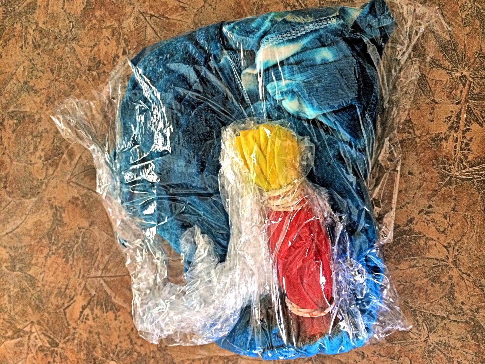 Dyed shirt wrapped tightly in plastic wrap to set