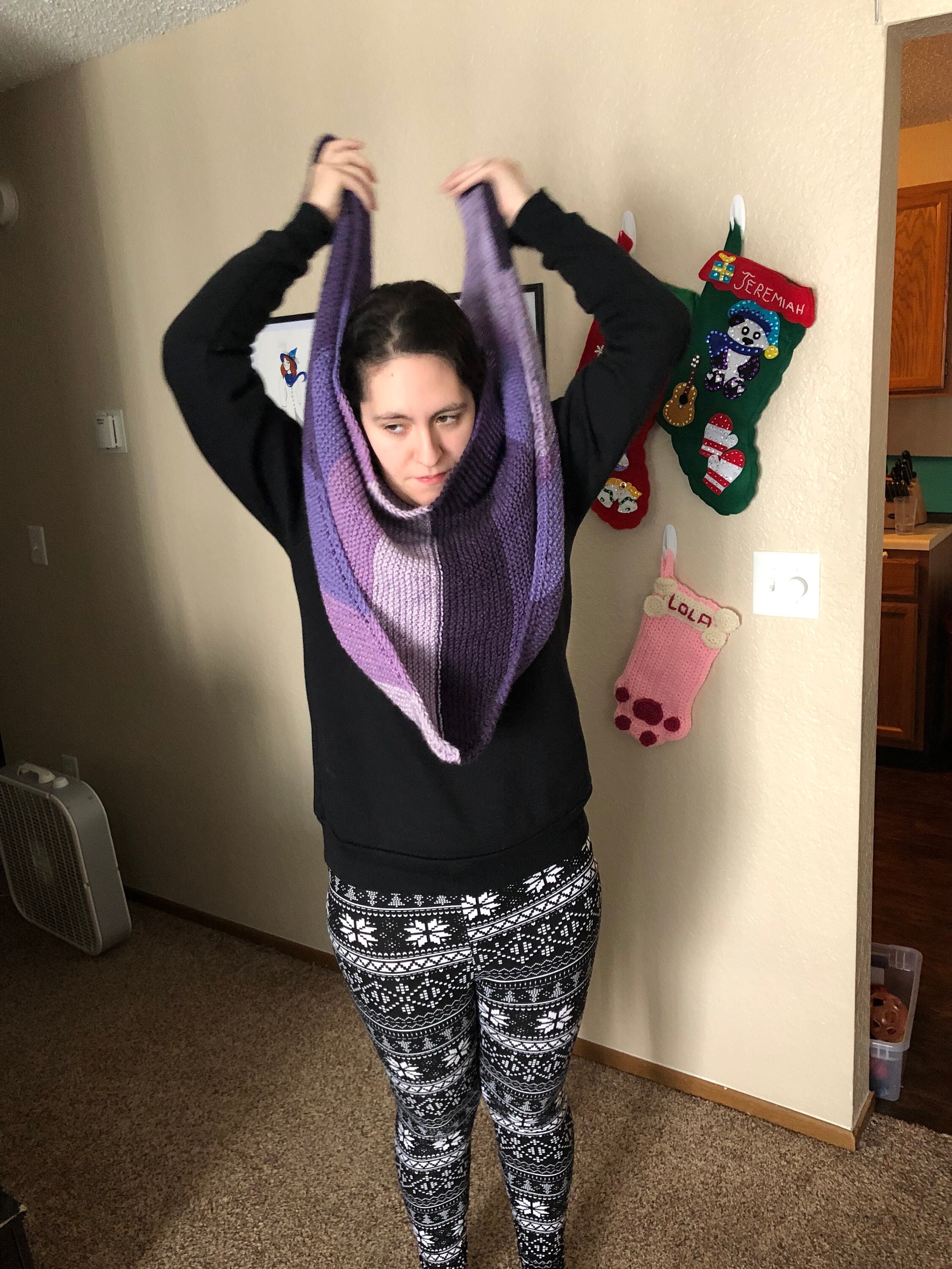 Woman putting on purple knit scarf