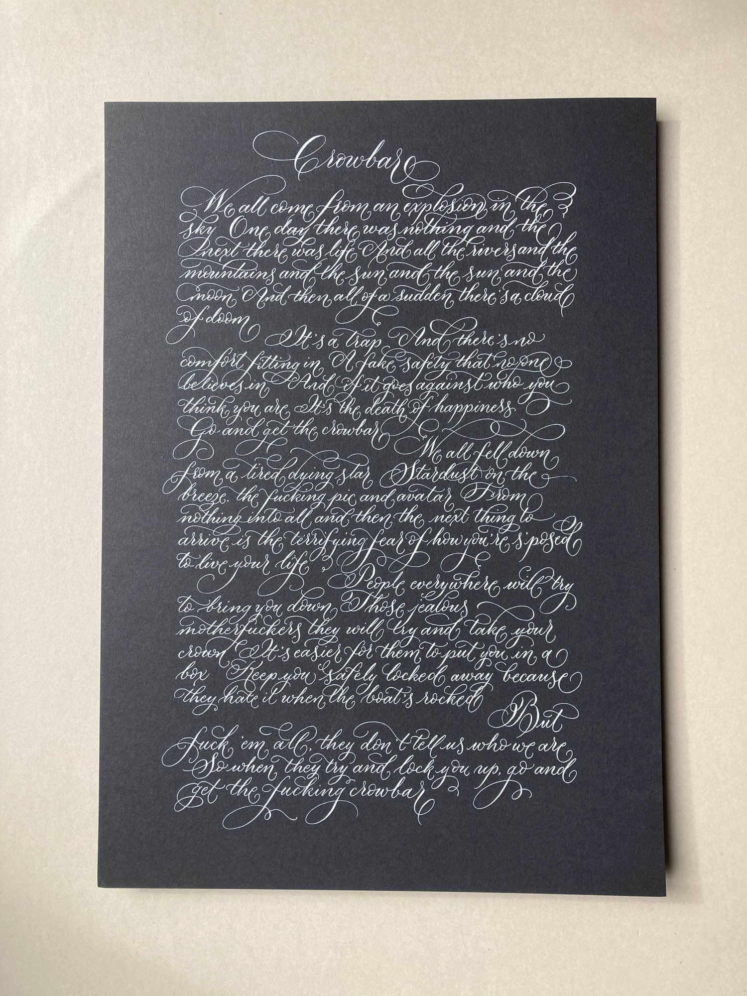 Crowbar calligraphy lyrics for practice using white ink on black paper