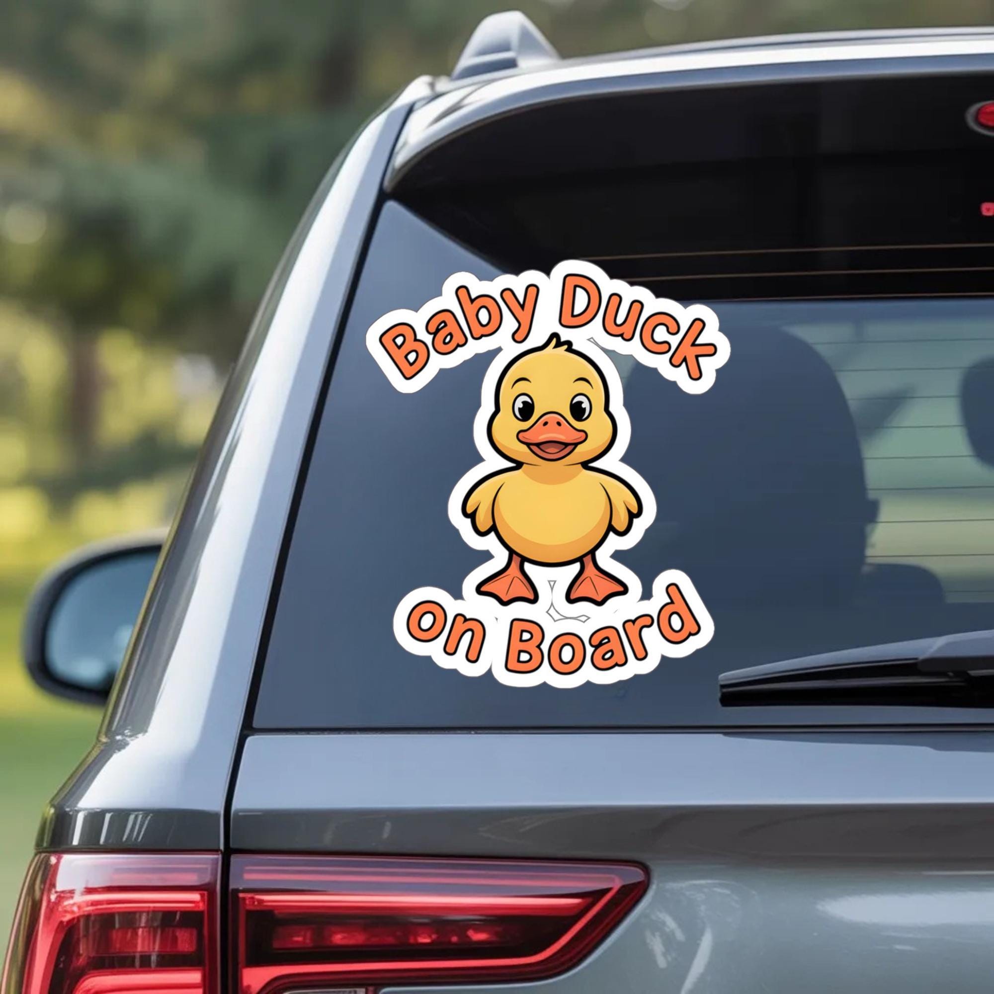 Cute “Baby Duck On Board” car sticker with a smiling yellow duck on a white vehicle bumper