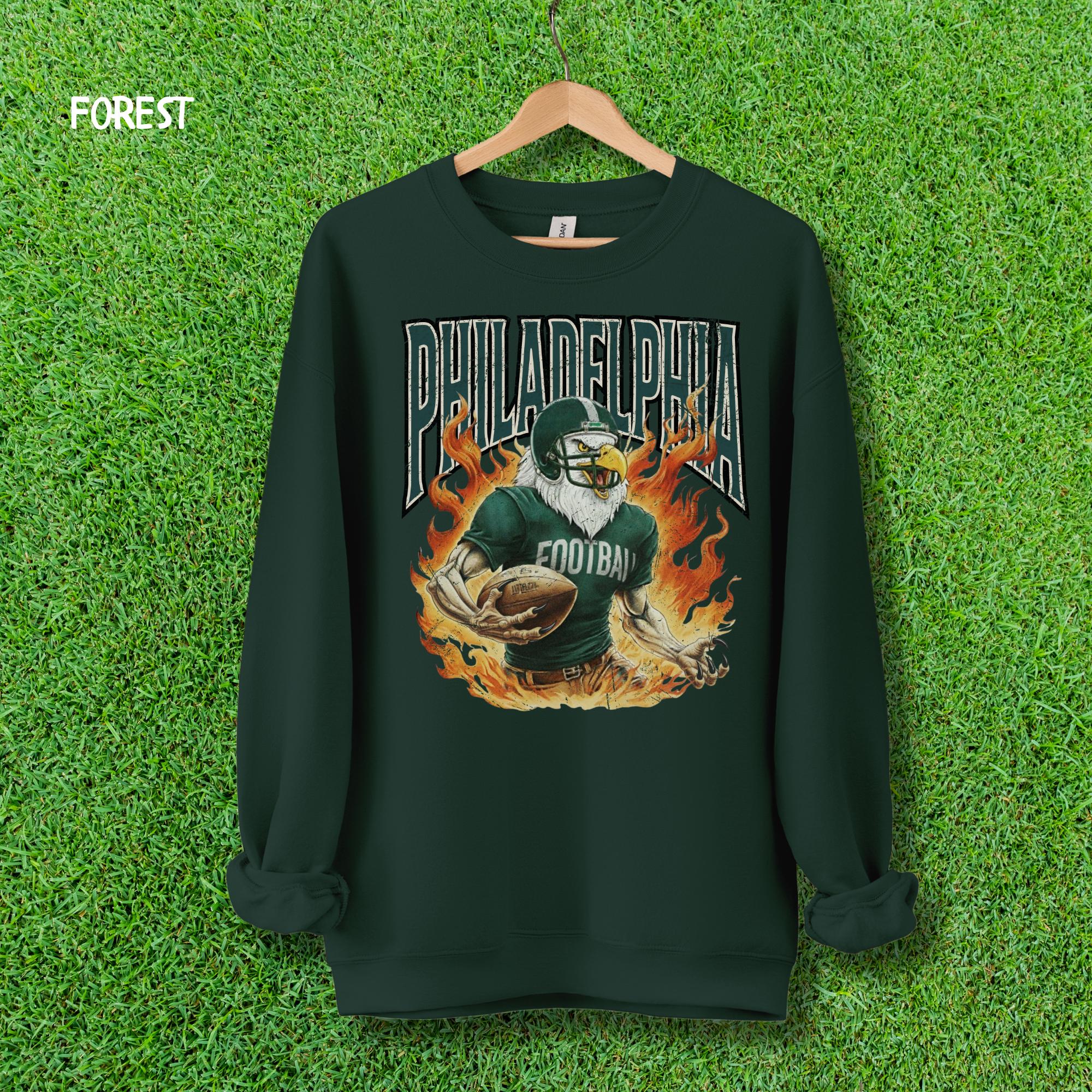 Forest green color sweatshirt mockup with the fiery Philadelphia Eagle mascot football design for game day apparel.