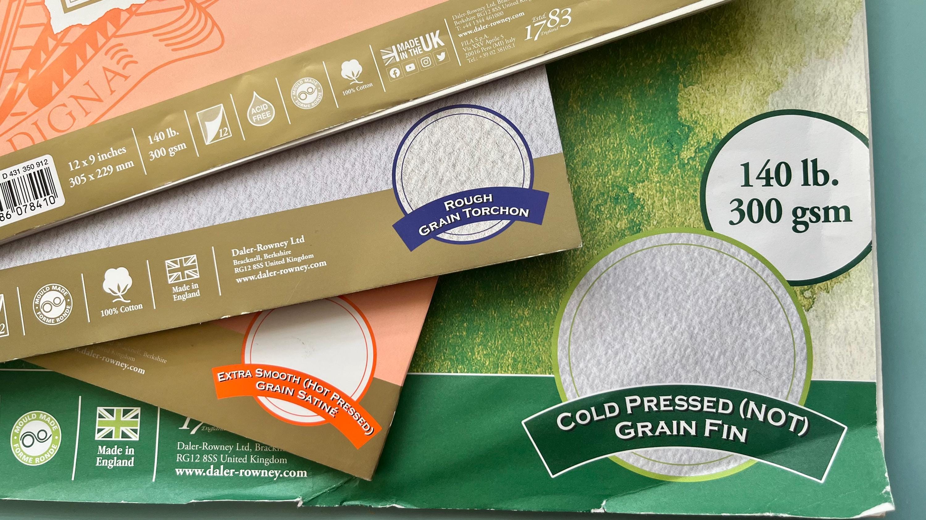 A selection of displayed Watercolour papers in pads of different surface textures.