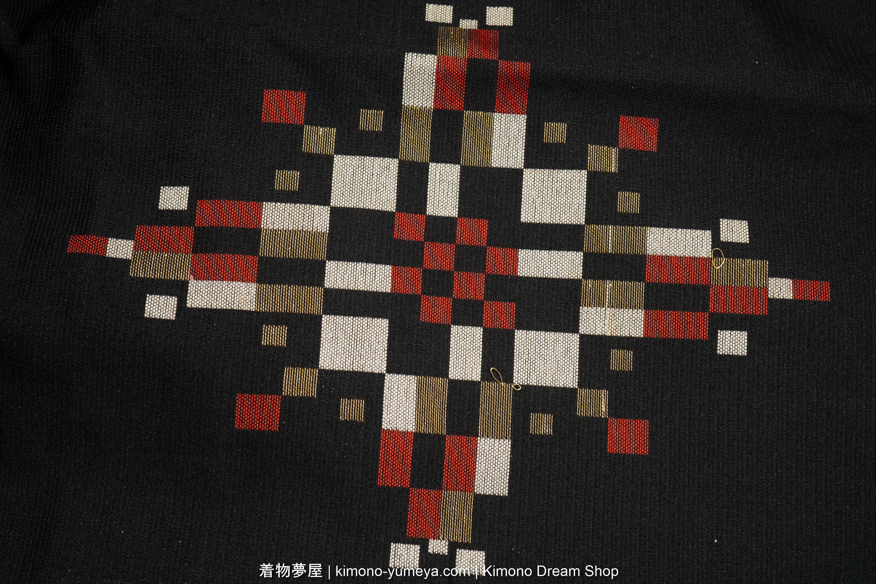 Black background with abstract, geometric hishi pattern. This resembles the look of a single Japanese water chestnut plant in the water.