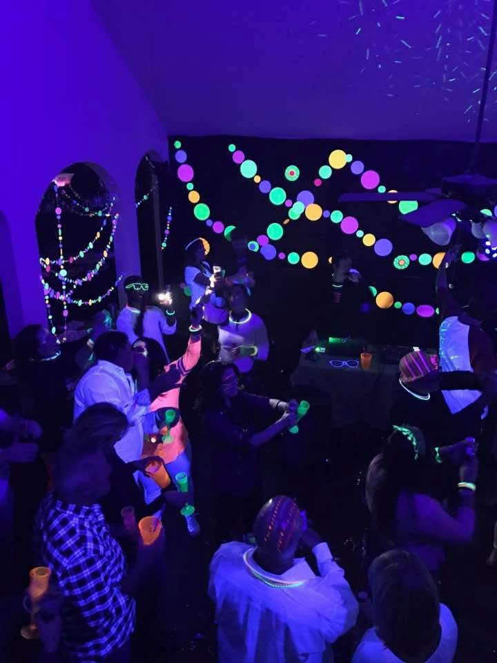 fluorescent large circle garlands in neon colors at a black light glow party