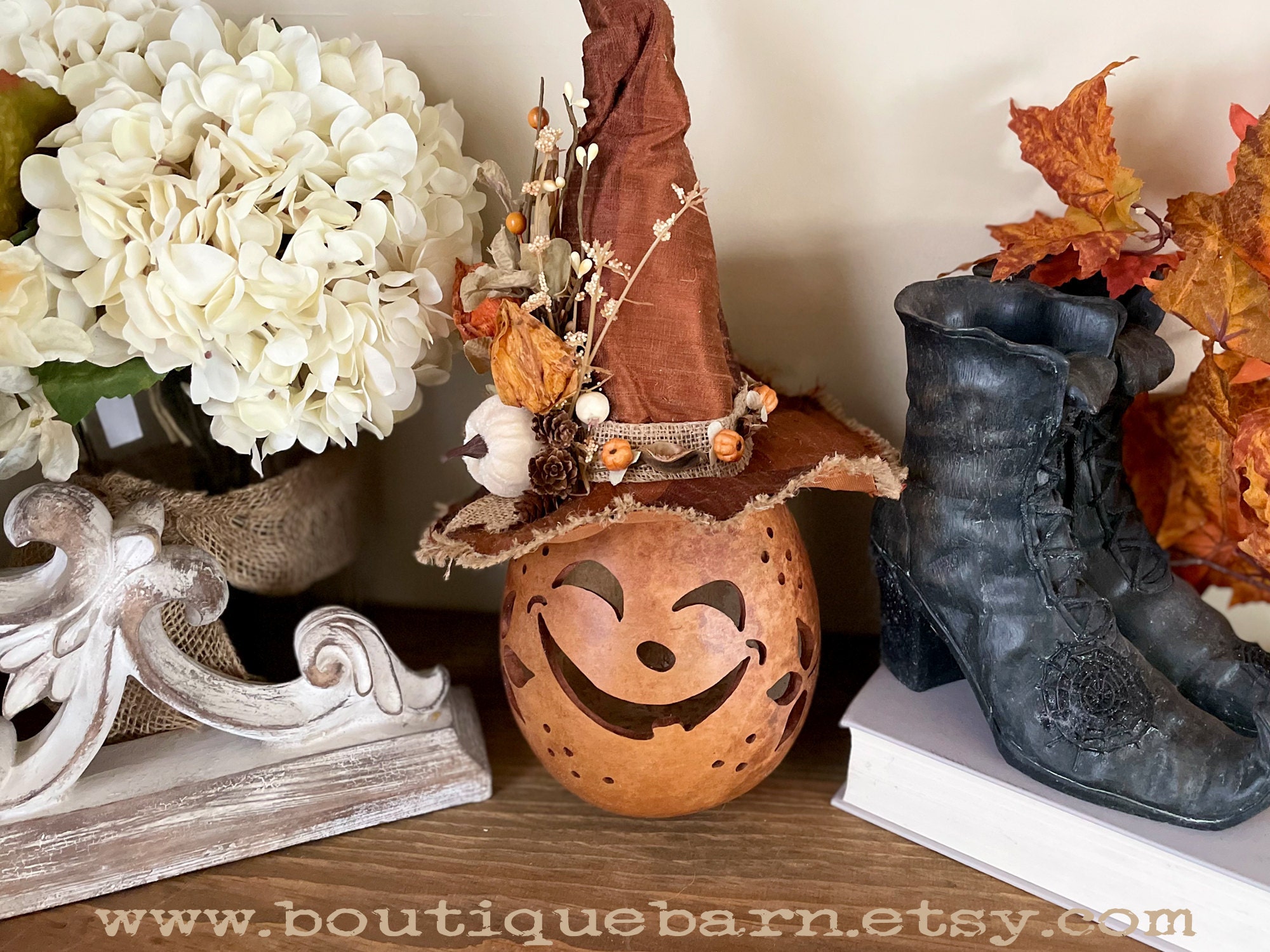 Carved fall pumpkin gourd with a handmade witch hat.