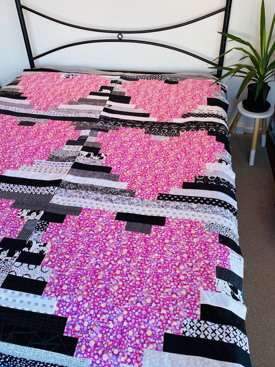 Photo of a Heart Quilt spread out over a bed. This quilt is called Heart Strings, by Alexa & Me.
