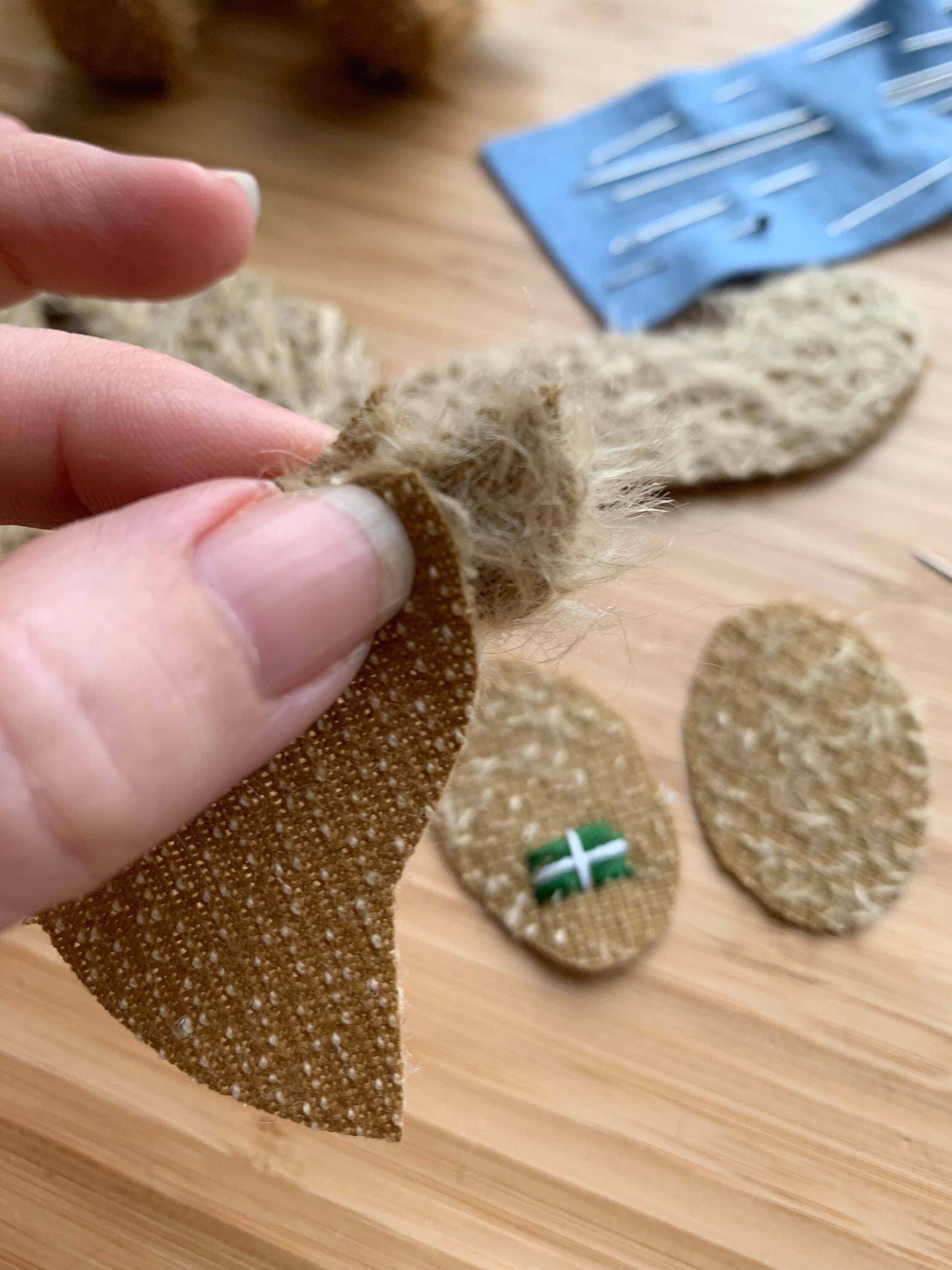 Sewing in the ears is one of the most difficult parts.  I carefully cut a slot in the gusset and side panel of the head.  I have to do this as Im going along and the placement of this creates the individual expression of each bear.