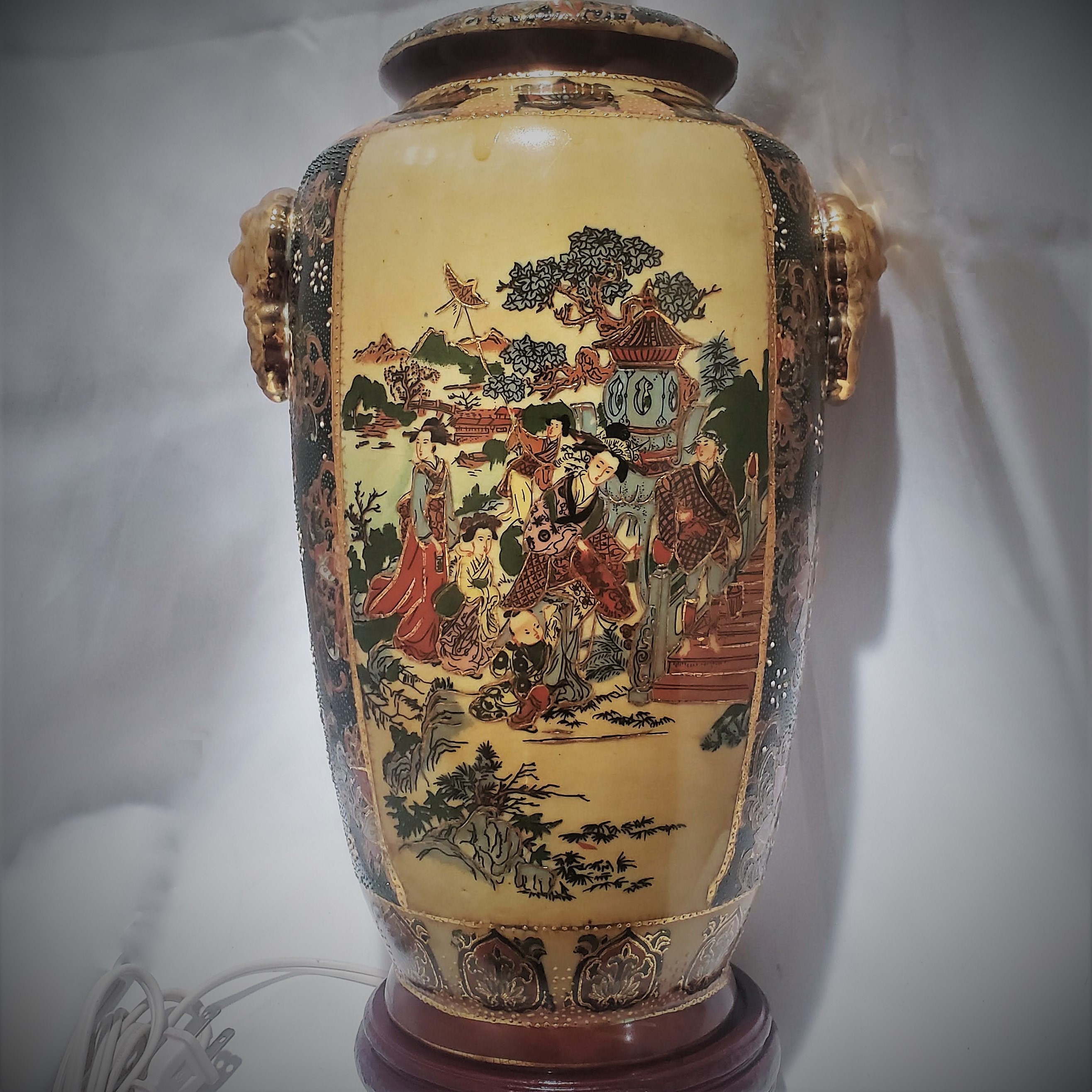 This stunning Satsuma-style lamp commands attention with its grand size, standing tall as a statement piece in any room. The intricate details of the hand-painted design are showcased on the lamps smooth surface, adding a touch of elegance and sophistication to any interior design setting.