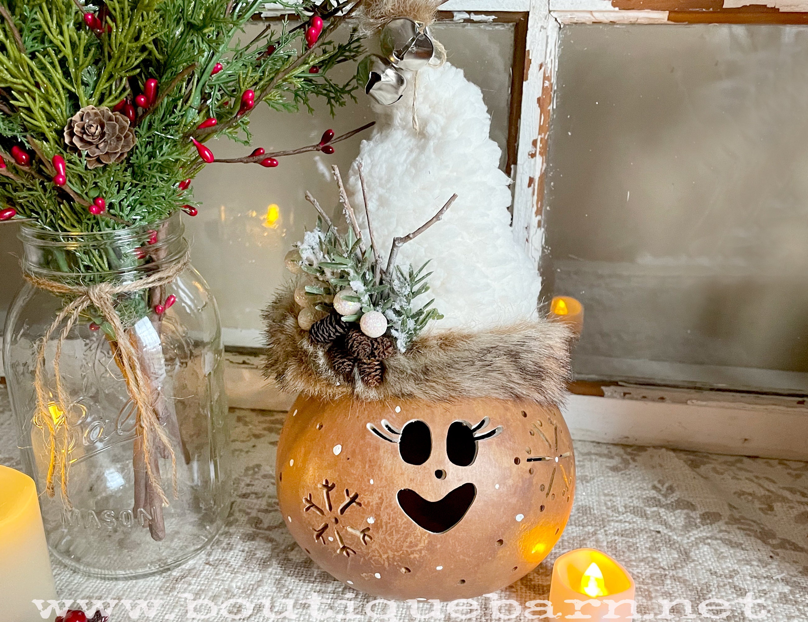 Handmade Christmas Elf decoration. A real dried gourd with a carved Elf face and snowflakes. A candle is included to ligght up the gourd. Her name is Tinsel. She had a handmade Sherpa and faux fur hat.