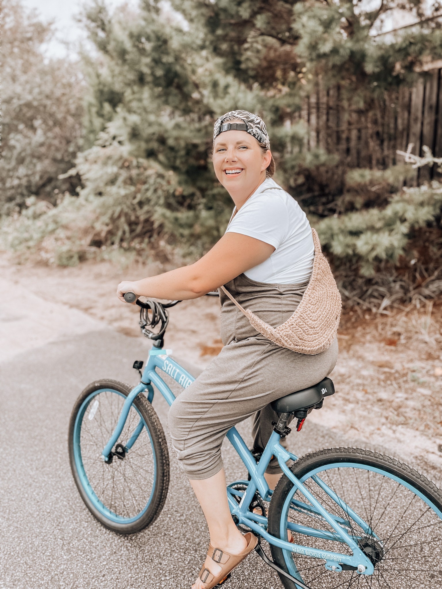 Woman on a bicycle with a crocheted bag