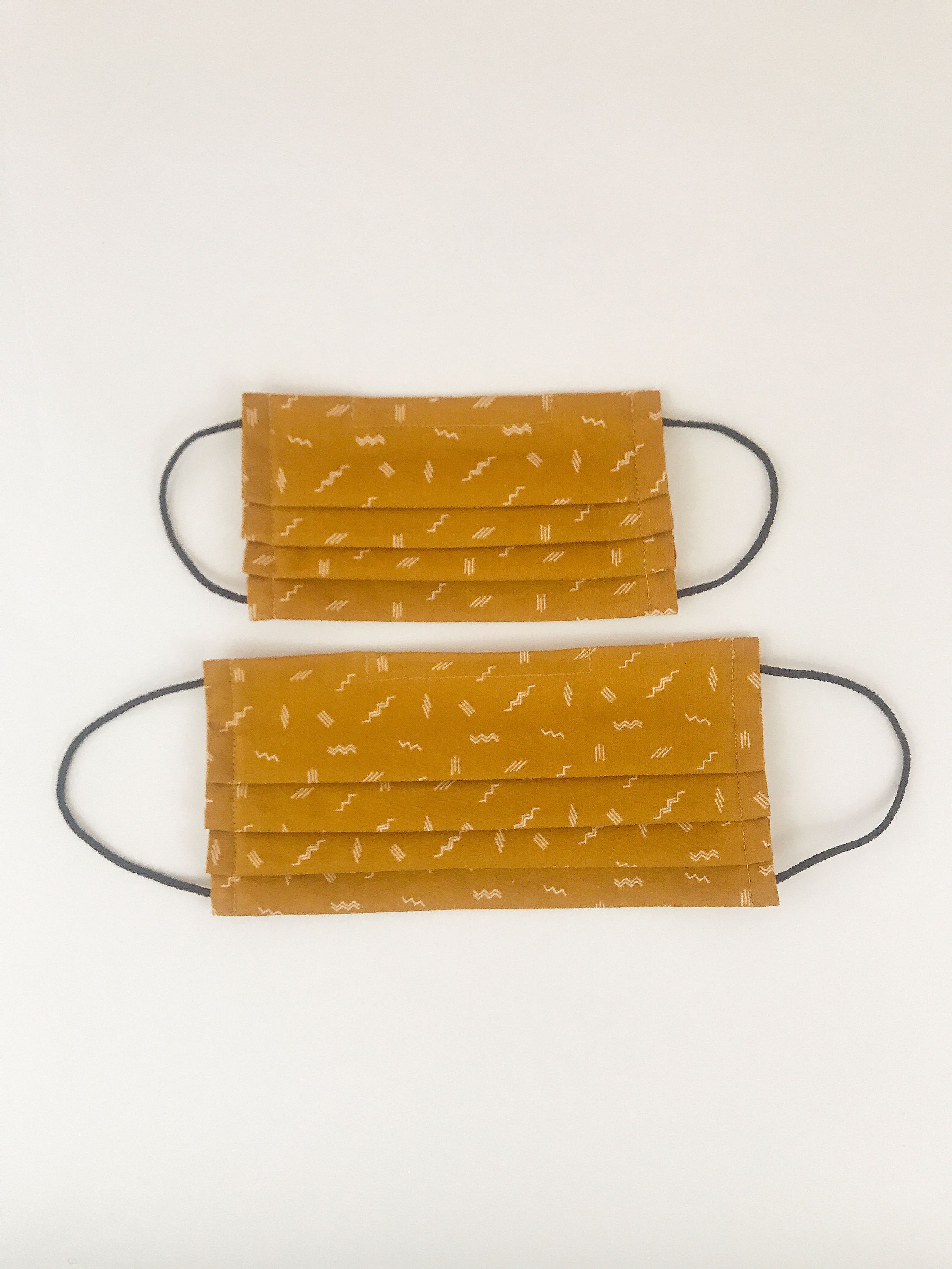 Pleated face masks for adults and children in ochre