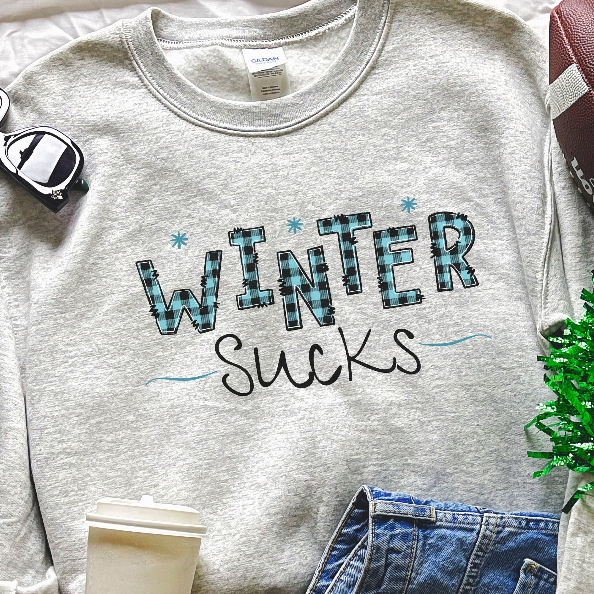 Winter Sucks blue plaid letters with tiny blue snowflakes