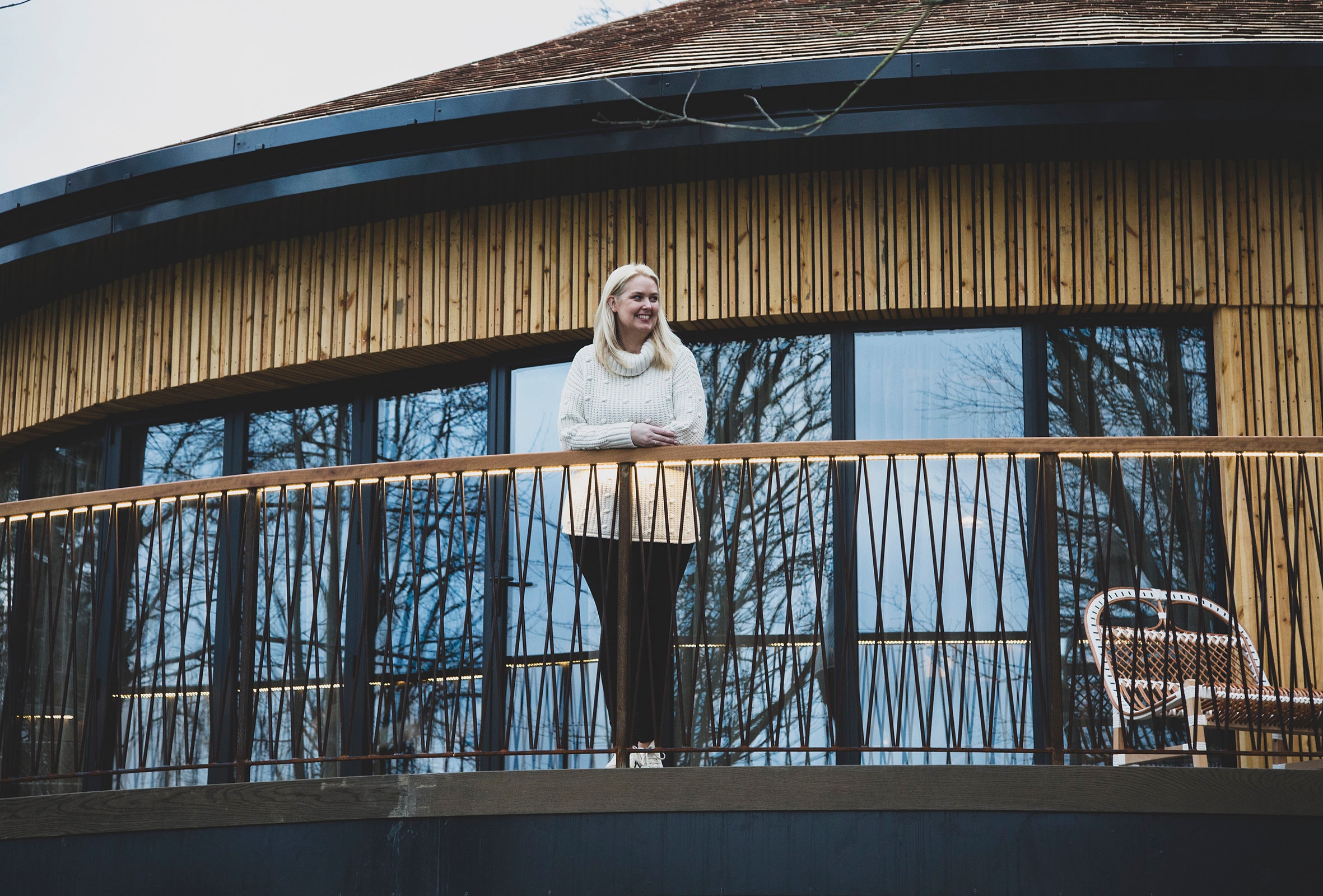 Louise standing on the balcony of the treehouse