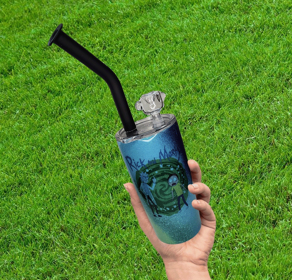 A hand holding a custom cup with a grassy background