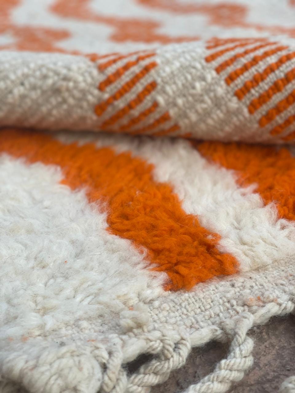 Handwoven orange and cream wave pattern rug