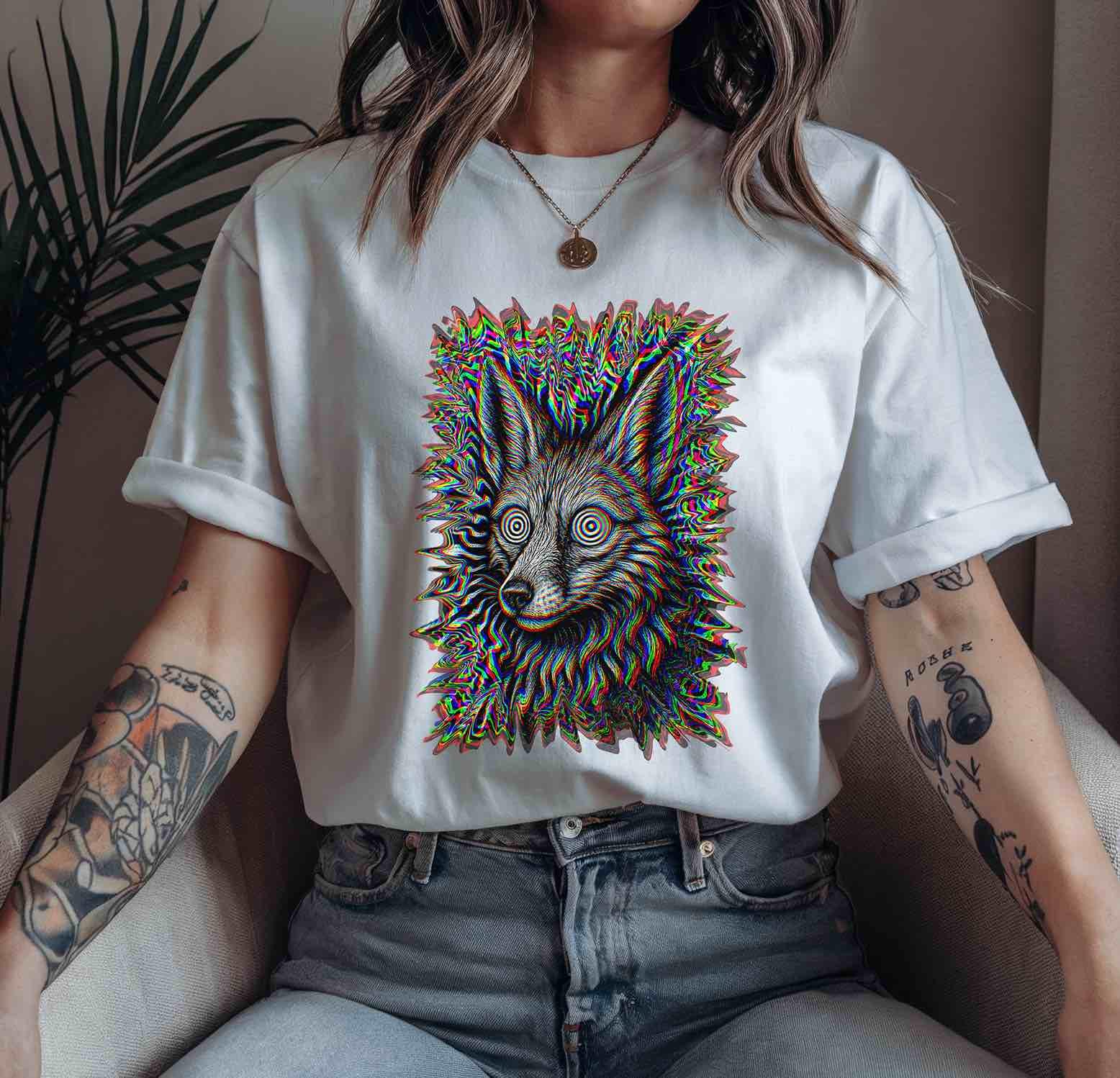 White unisex tee featuring hypnotic jackal glitch art; casual rolled sleeves on seated model; clean, minimalist styling for alt-fashion lovers.