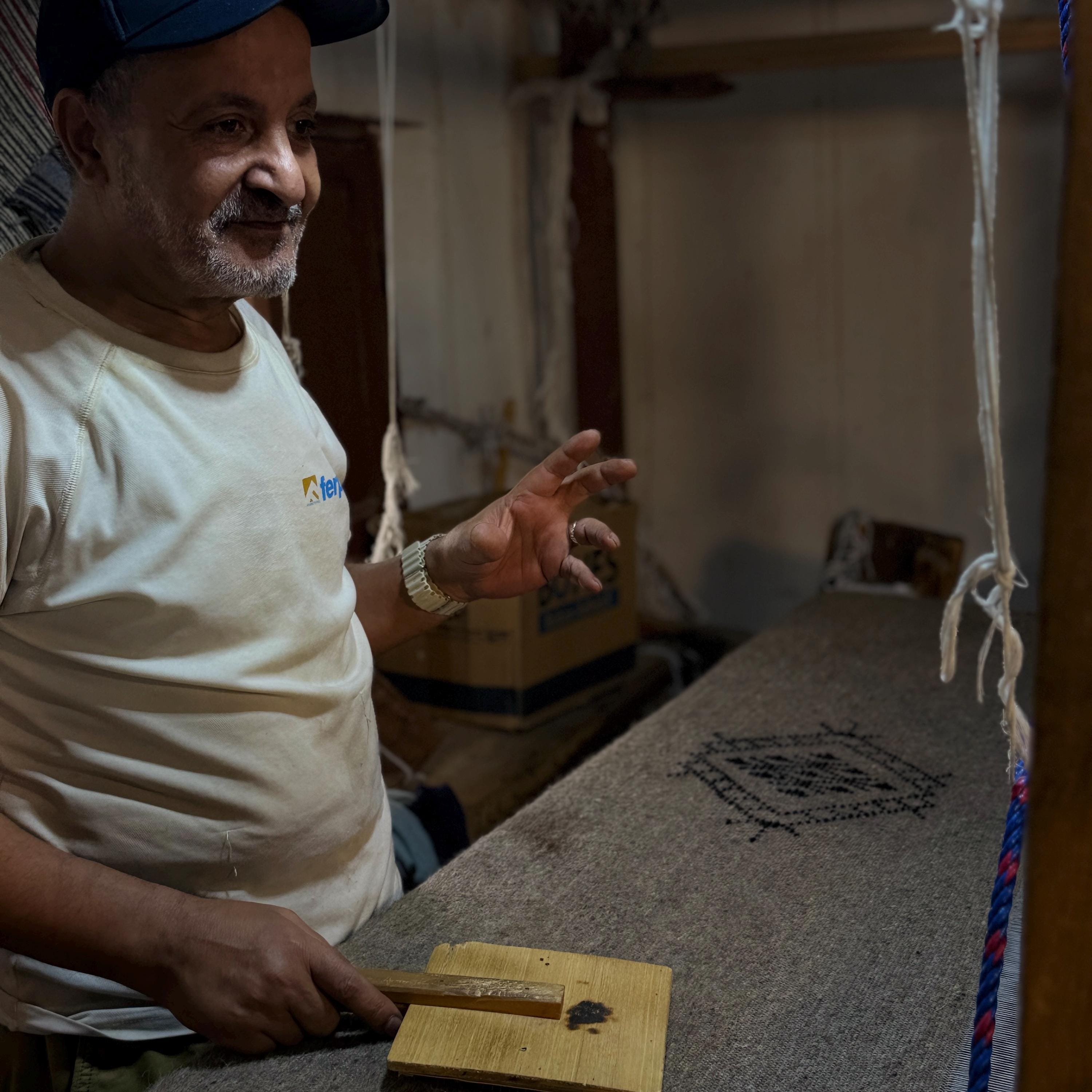 Figure 9. My father explaining a motif. This knowledge has never existed in a book — it moves from hand to hand.