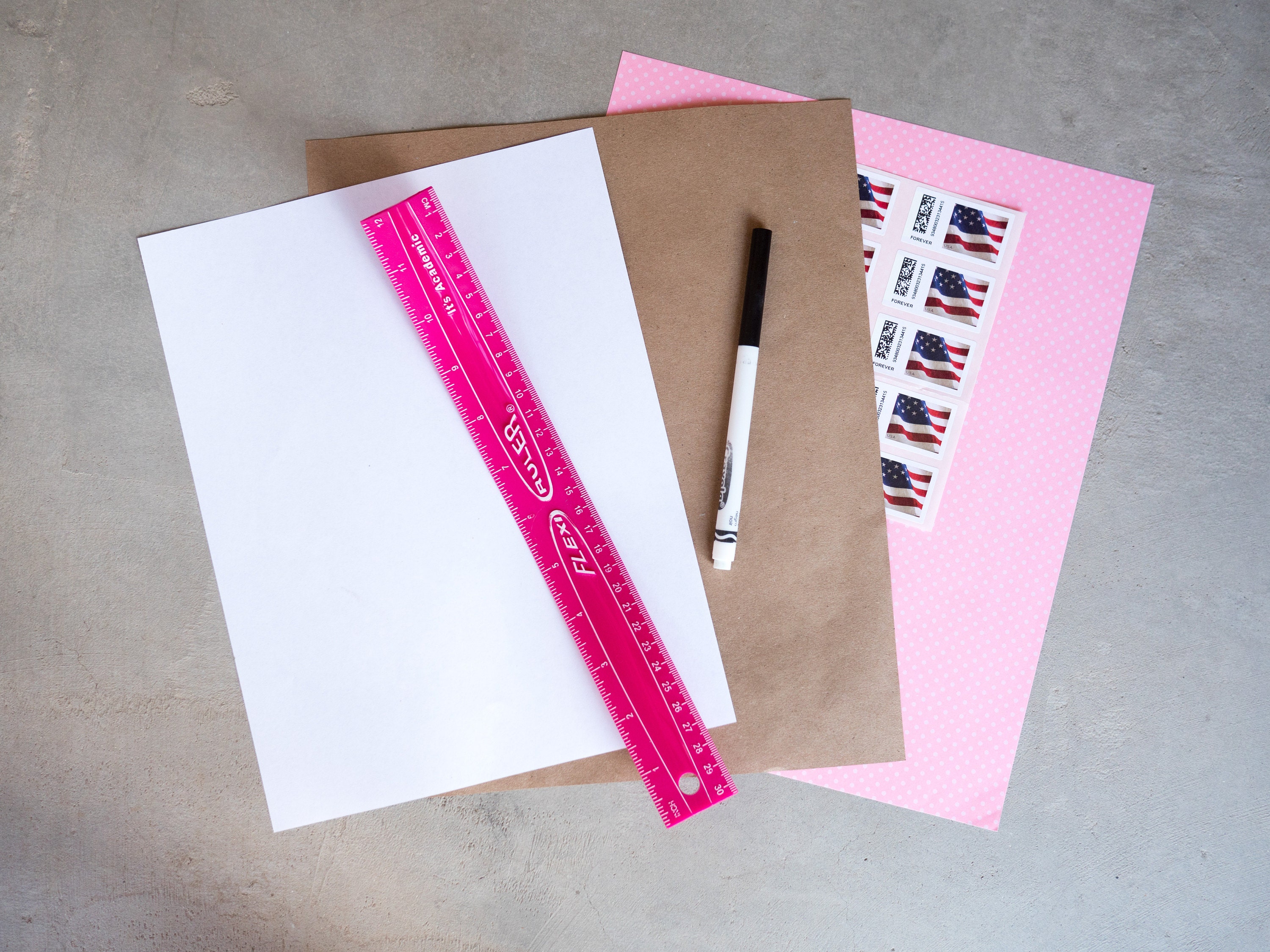 Supplies needed for folding a letter into an envelope