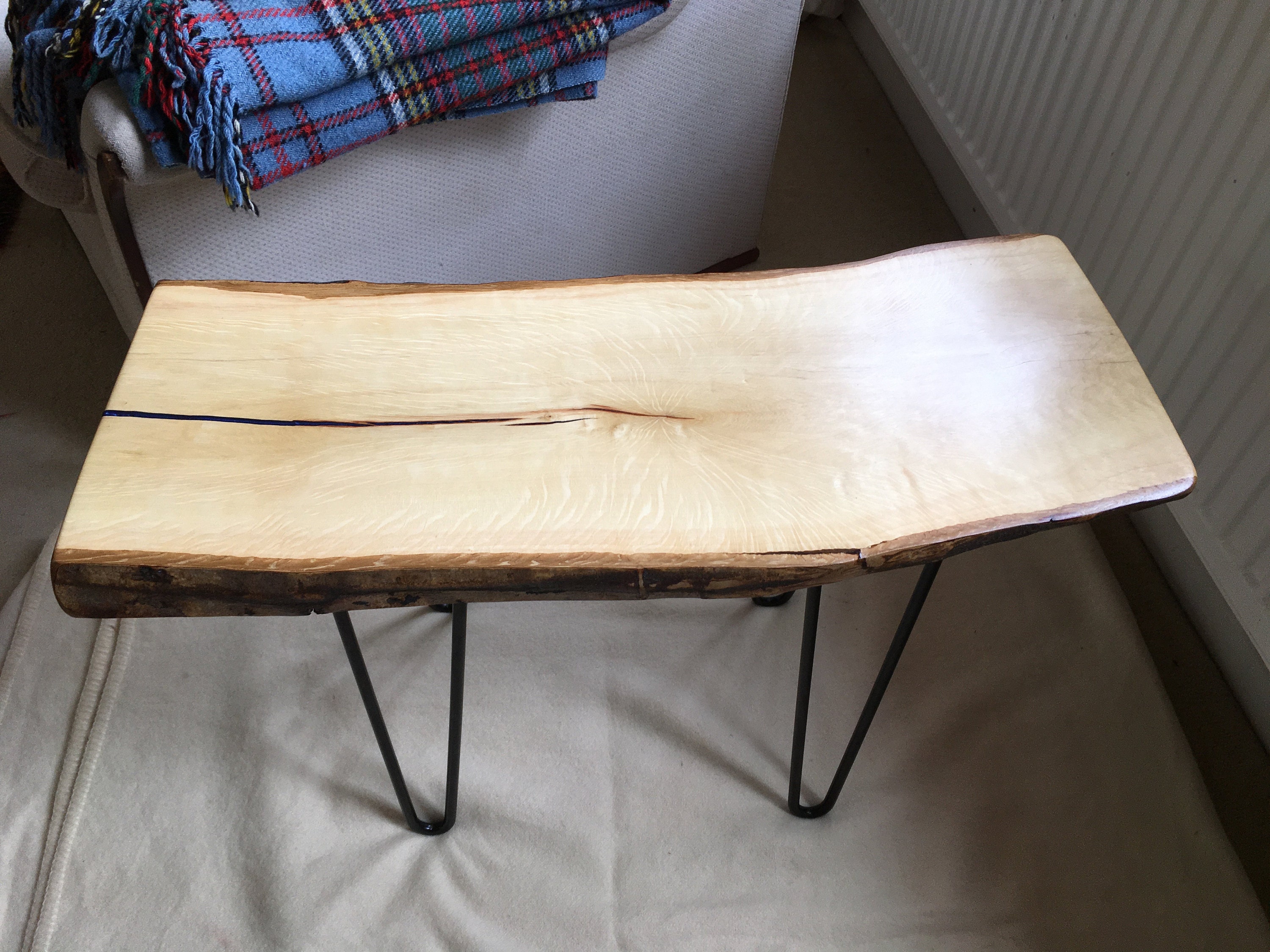 Blue epoxy filled crack on hornbeam table