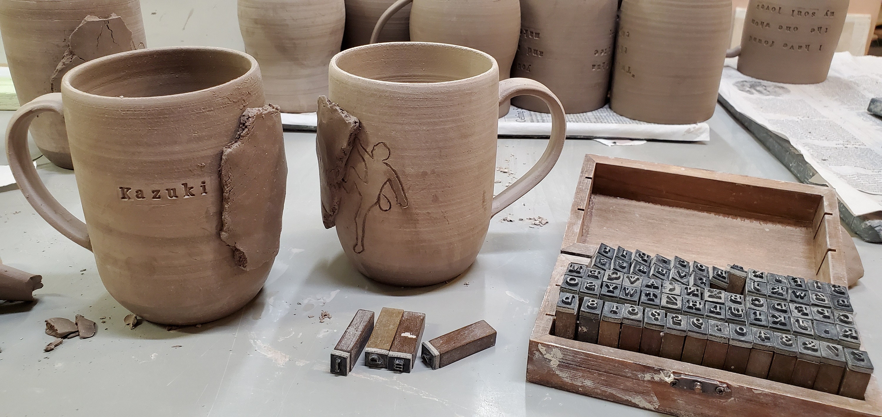 stamping a name into a rock climbing mug