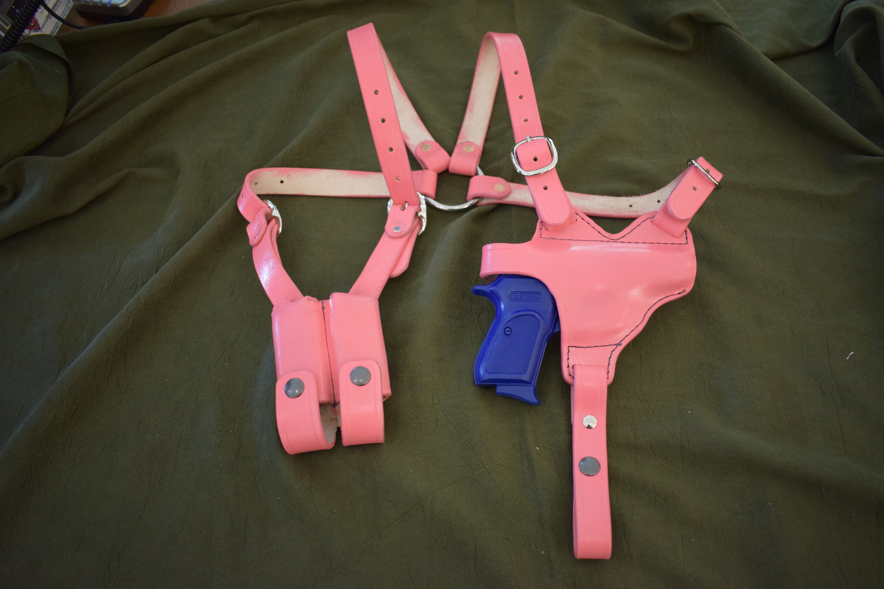 A hot pink leather shoulder holster