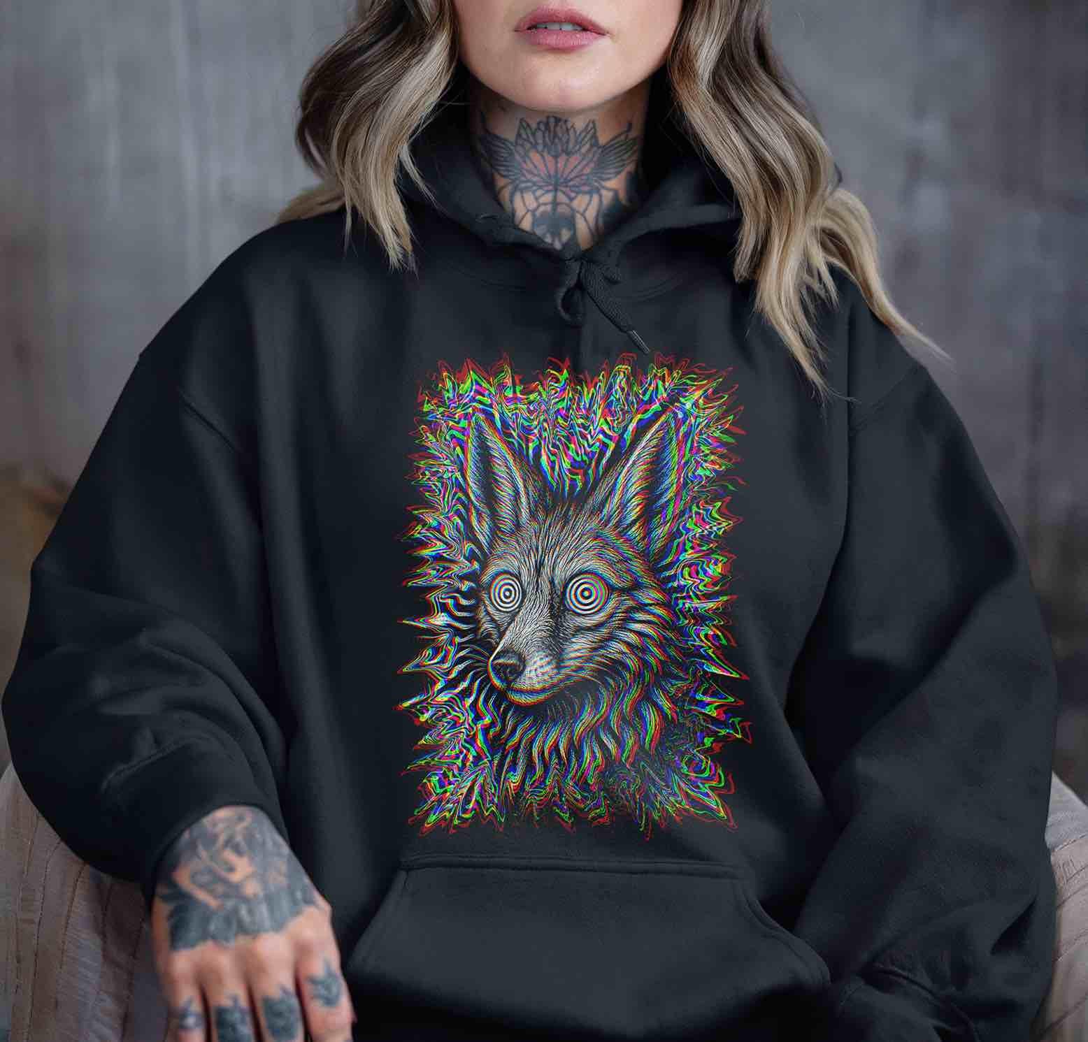 Cozy black hoodie with Trippy Jackal RGB glitch design; relaxed fit on model; dark gothic streetwear hoodie for nightlife and chill seasons.