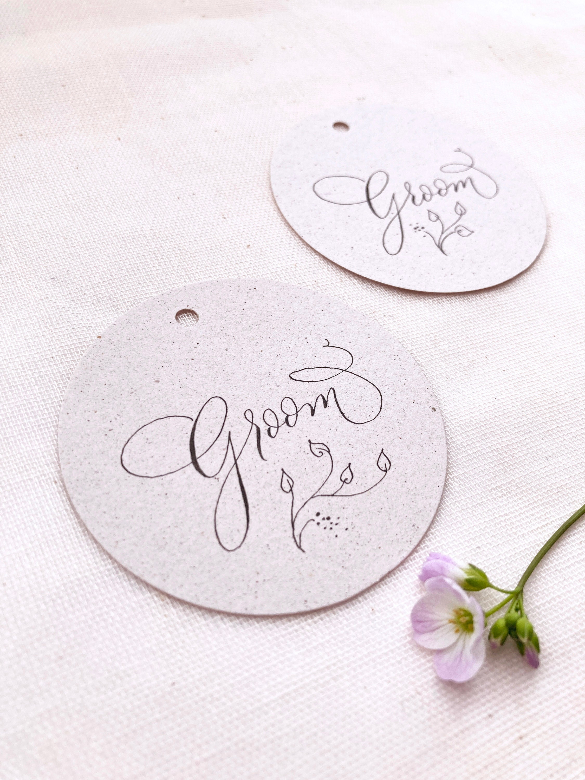 Recycled circle wedding name tags with calligraphy