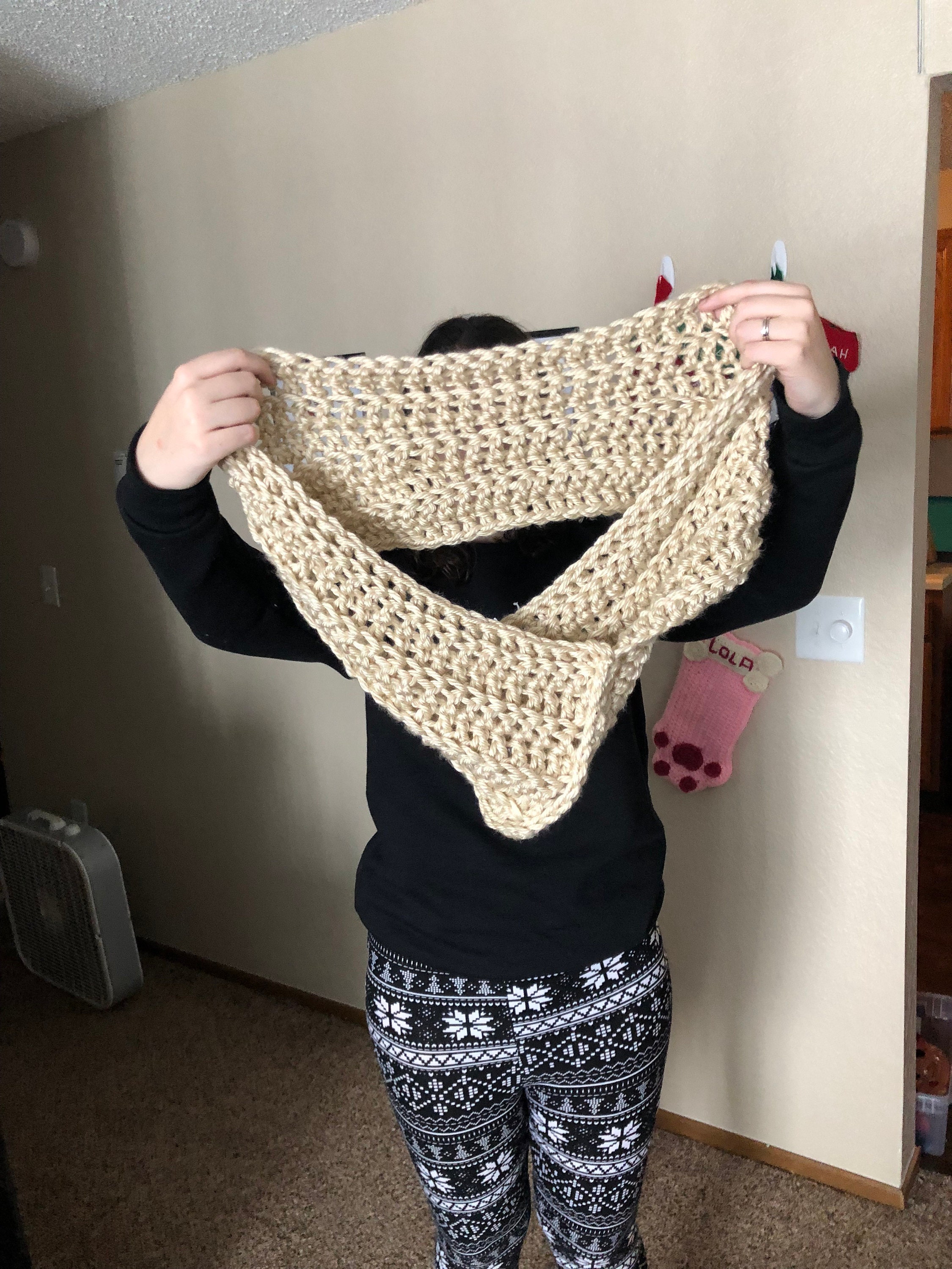 Woman holding crochet cowl