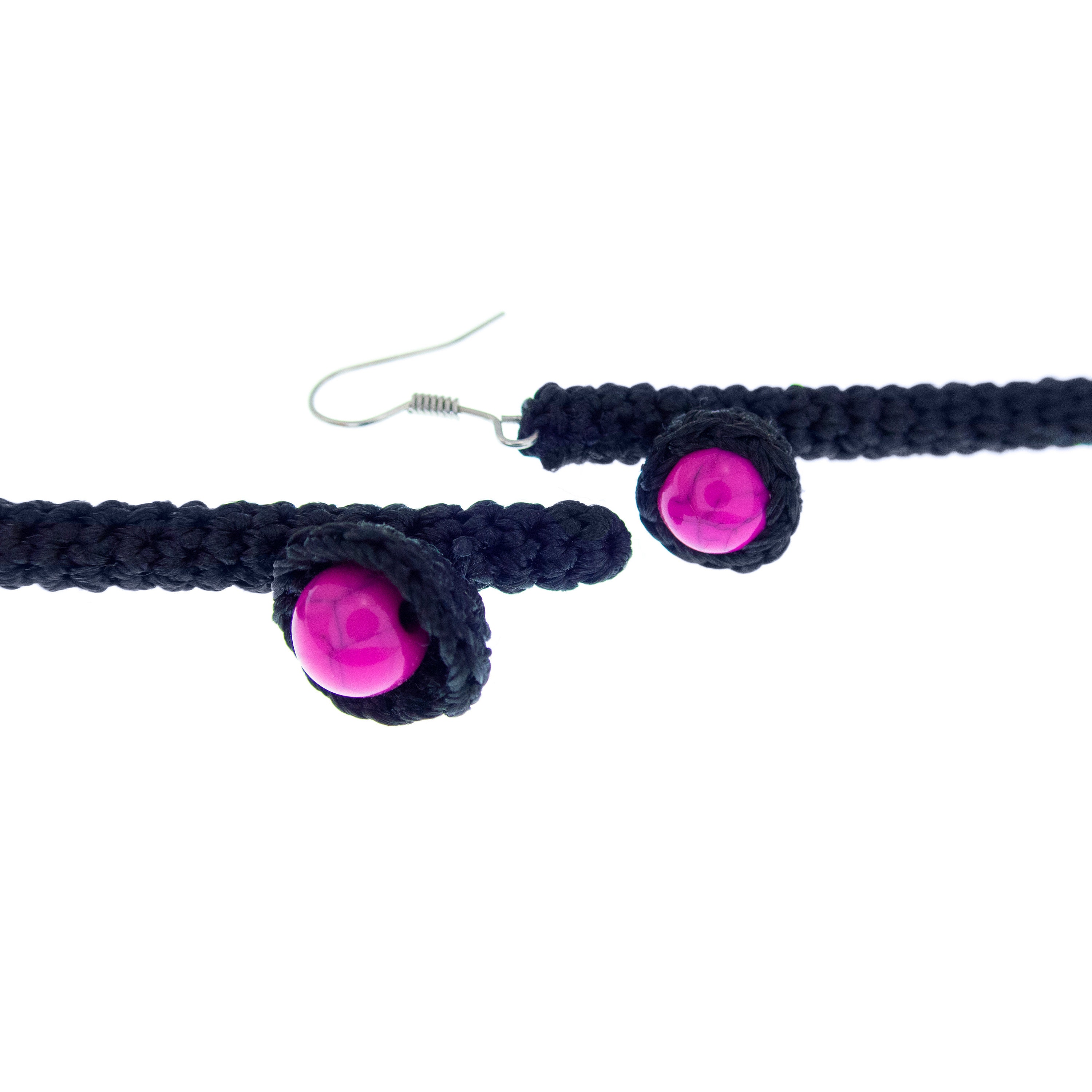 handmade mismatched earrings dangle in black and pink