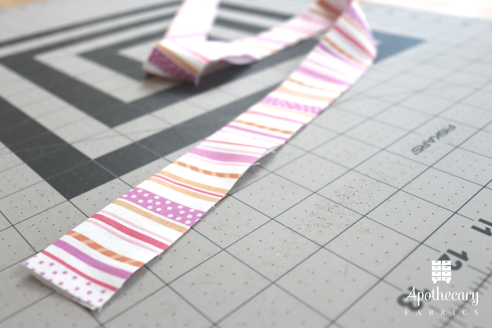 Trim piece of fabric, folded in half lengthwise and pressed flat.