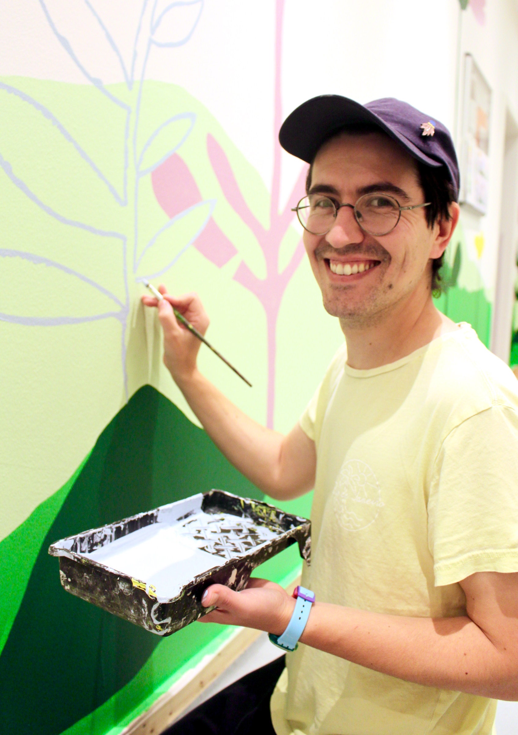 Ben Craig painting mural for kindergarten