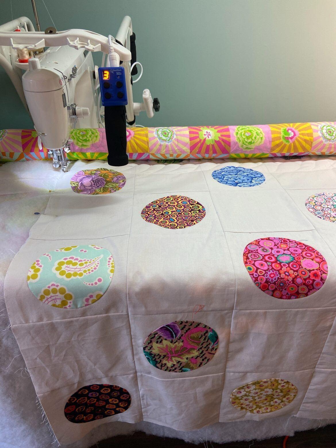 patchwork quilt top on longarm quilting machine